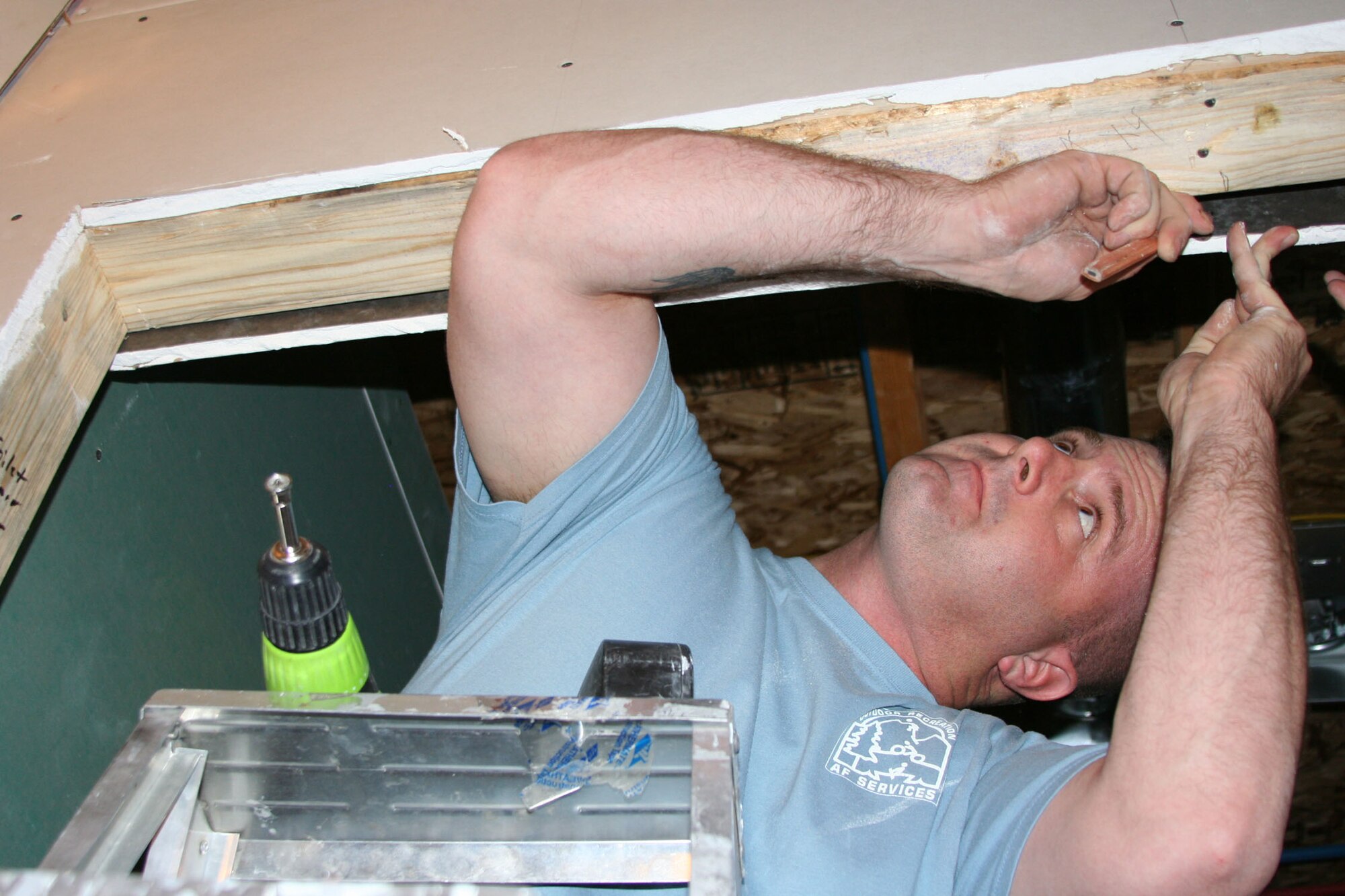 2nd Lt. David Bible, 564th Missile Squadron missileer, installs drywall at a home constructed by volunteers with Habitat for Humanity in Great Falls, Mont. Lieutenant Bible was one of five company grade officers who volunteered to help a local family with building their home Aug. 29. The home’s projected completion date is the end of October. (U.S. Air Force photo/Senior Airman Eydie Sakura).