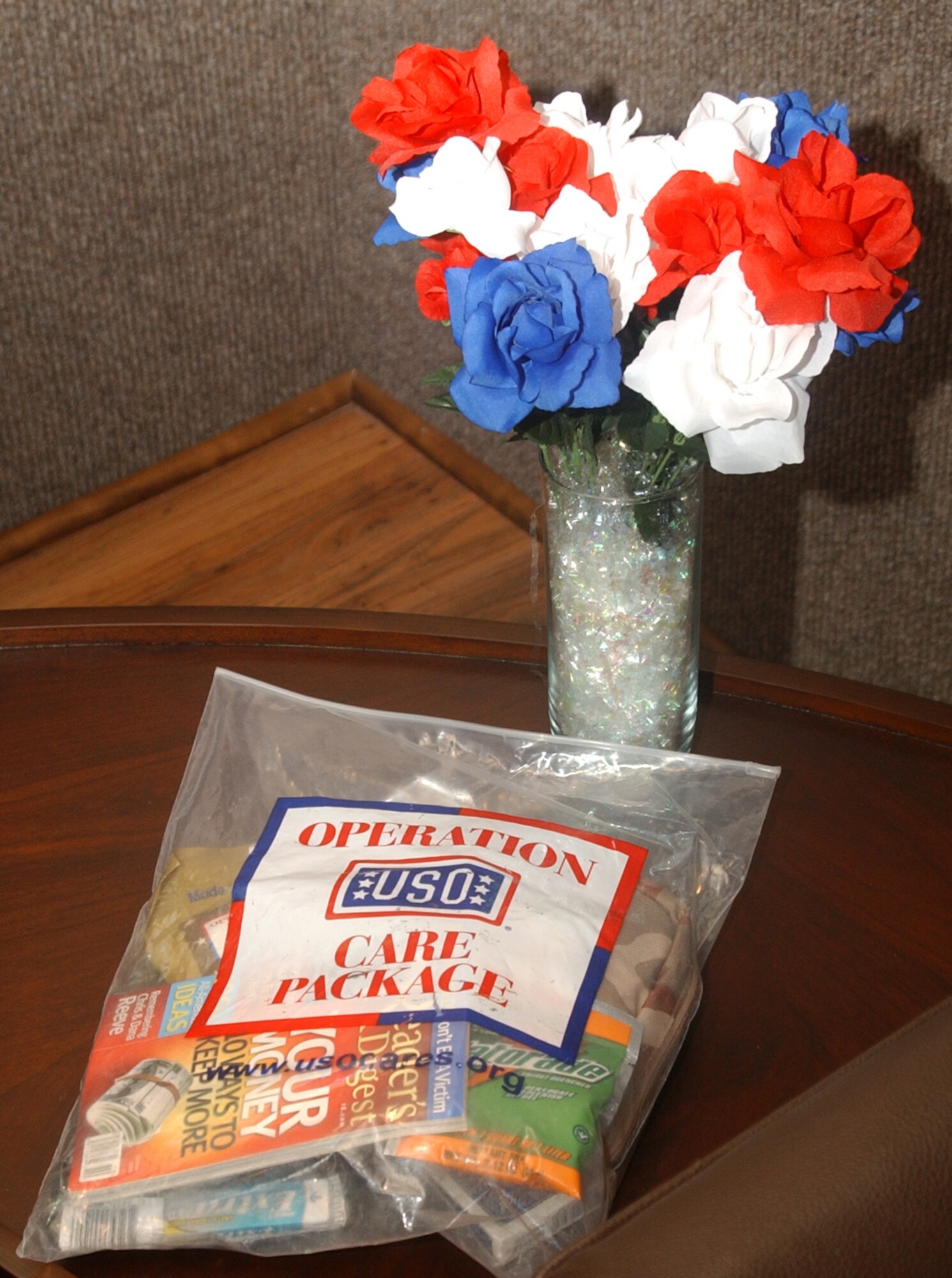 "Operation Care Package" provides deployed servicemembers with pre-paid international calling cards, playing cards, disposable cameras, a copy of "Reader's Digest" and snacks, as shown here. The United Services Organization in conjunction with a nationwide financial company made a stop in Great Falls at the Montana Veterans Memorial Aug. 27during its 70-city tour to collect donations to help raise funds for the care packages . (U.S. Air Force photo/Airman 1st Class Dillon White)