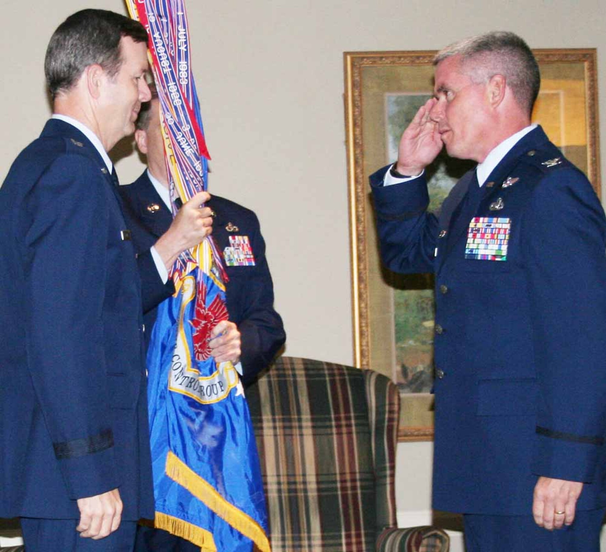 Col. John E. Trnka Jr. prepares to accept the 513th Air Control Group flag from Brig. Gen. Thomas R. Coon, 10th Air Force commander, during the change of command ceremony July 15. (Air Force photo)