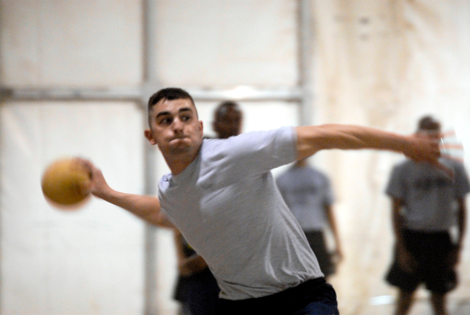 Senior Airman Lee Davis throws a dodge ball during the first ever coalition games held Aug. 25 at Camp Adder and Ali Base, Iraq. The Air Force team took first place in the event. The coalition games brought together teams from the U.S. Air Force, Army and Navy, along with Australians and Romanian teams to compete for barging rights as the best on base. The U.S. Air Force came out on top, taking first place in five events. Airman Davis is a member of the 407th Expeditionary Communications Squadron at Ali Base. (U.S. Air Force Photo/Master Sgt. Robert Valenca)  
     

