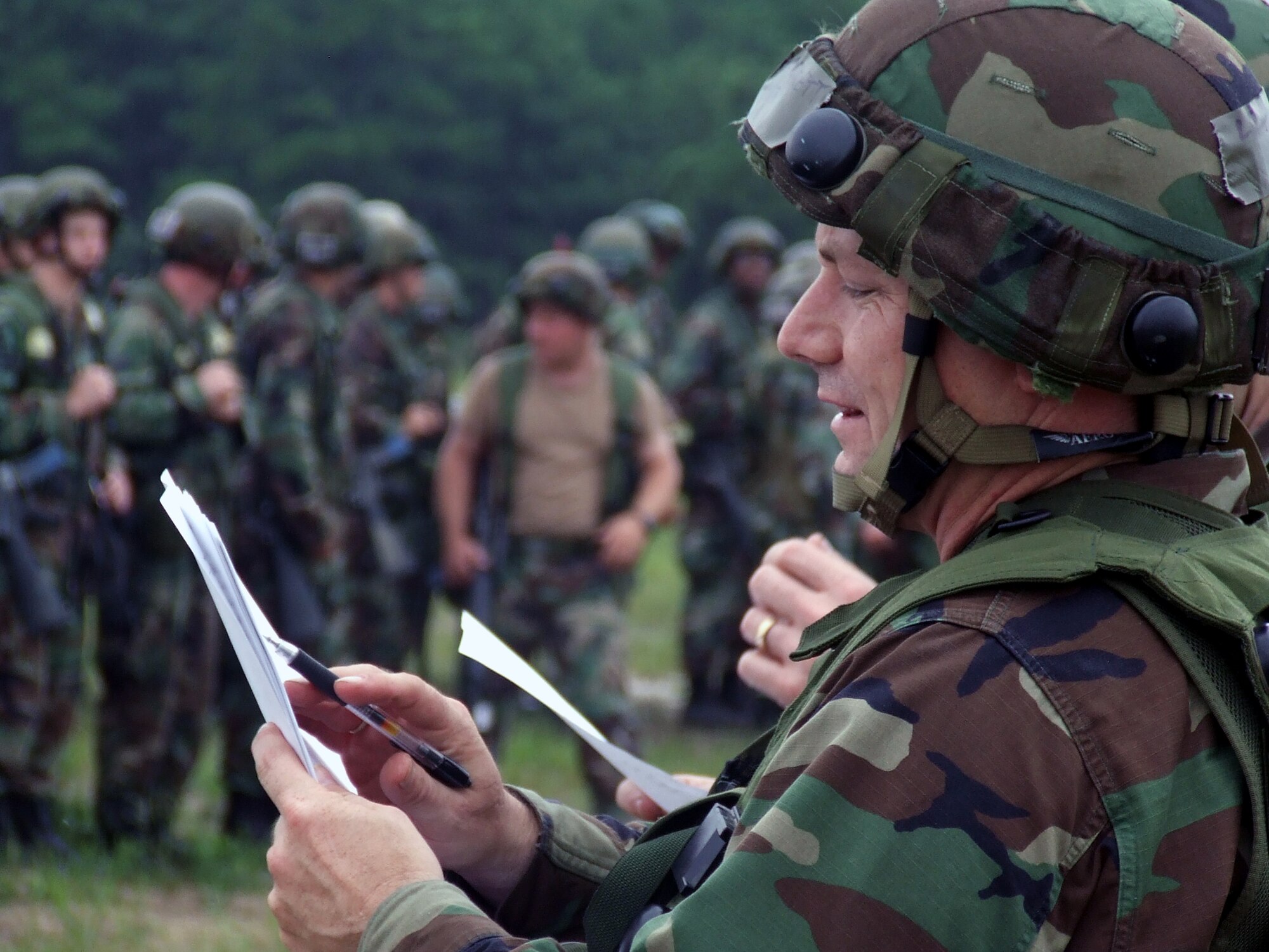 Airmen deployed with the fictional 421st Air Expeditionary Group form up for a roll call for accountability during operations for Air Force Exercise Eagle Flag 07-6 at Naval Air Engineering Station Lakehurst, N.J., Aug. 26.  The exercise is operated by the U.S. Air Force Expeditionary Center's 421st Combat Training Squadron from Fort Dix, N.J., and tests Airmen on their expeditionary combat support skills.  (U.S. Air Force Photo/Tech. Sgt. Scott T. Sturkol)
