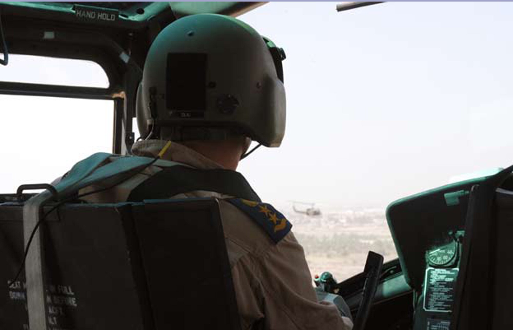 TAJI, Iraq – An Iraqi Air Force pilot navigates the skies during a patrol of the electrical infrastructure near the Taji military base. A typical patrol mission involves two Huey II helicopters and one Cessna Caravan for overwatch, scanning ahead and spotting potential enemy activity. (U.S. Air Force photo / Senior Airman Christie Putz)
