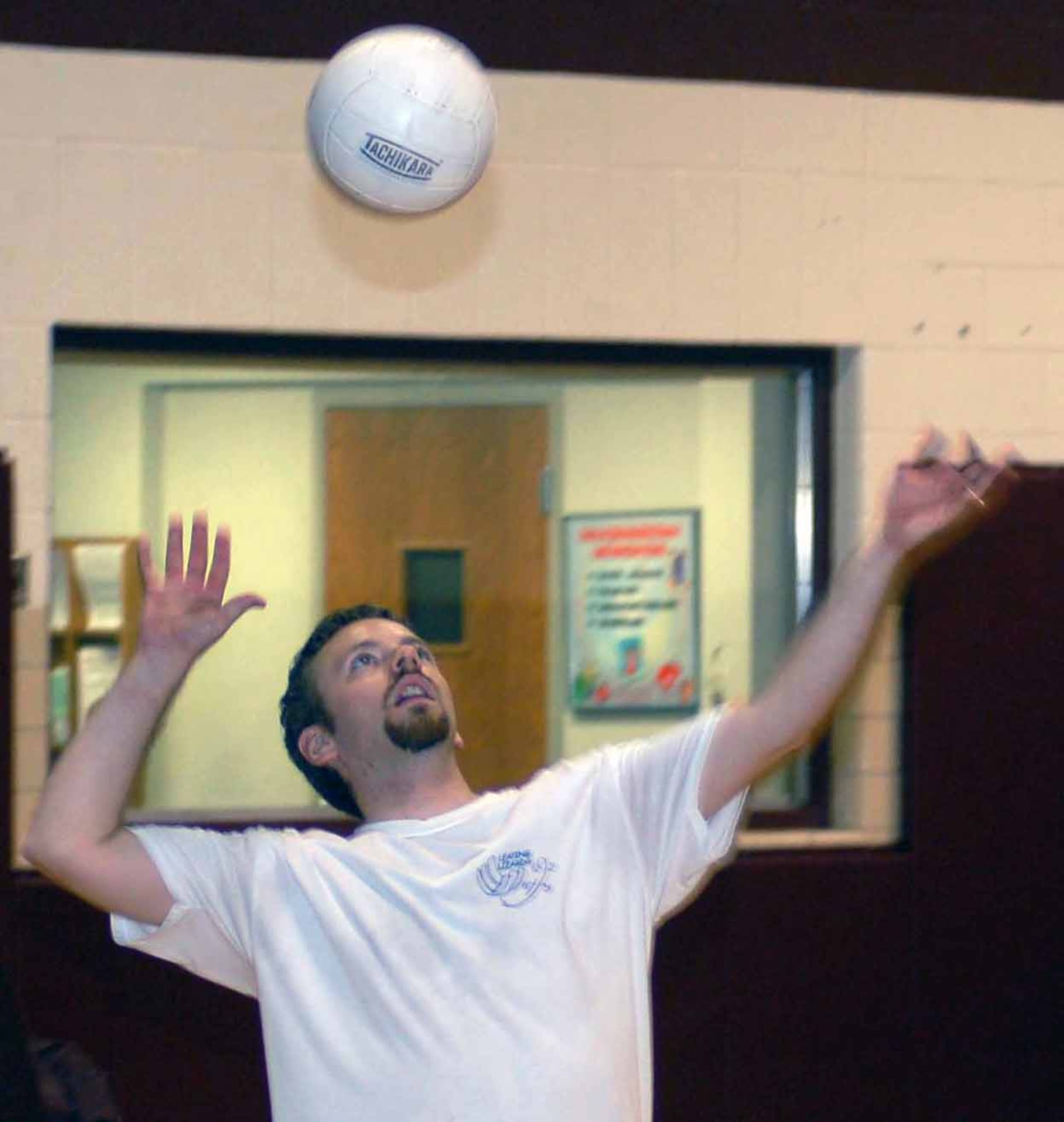 Leaping Lizards setter Ben Tyson delivers a serve in game one of a match against the 963rd AACS/Services team Aug. 22. (Air Force photo by John E. Banks) 