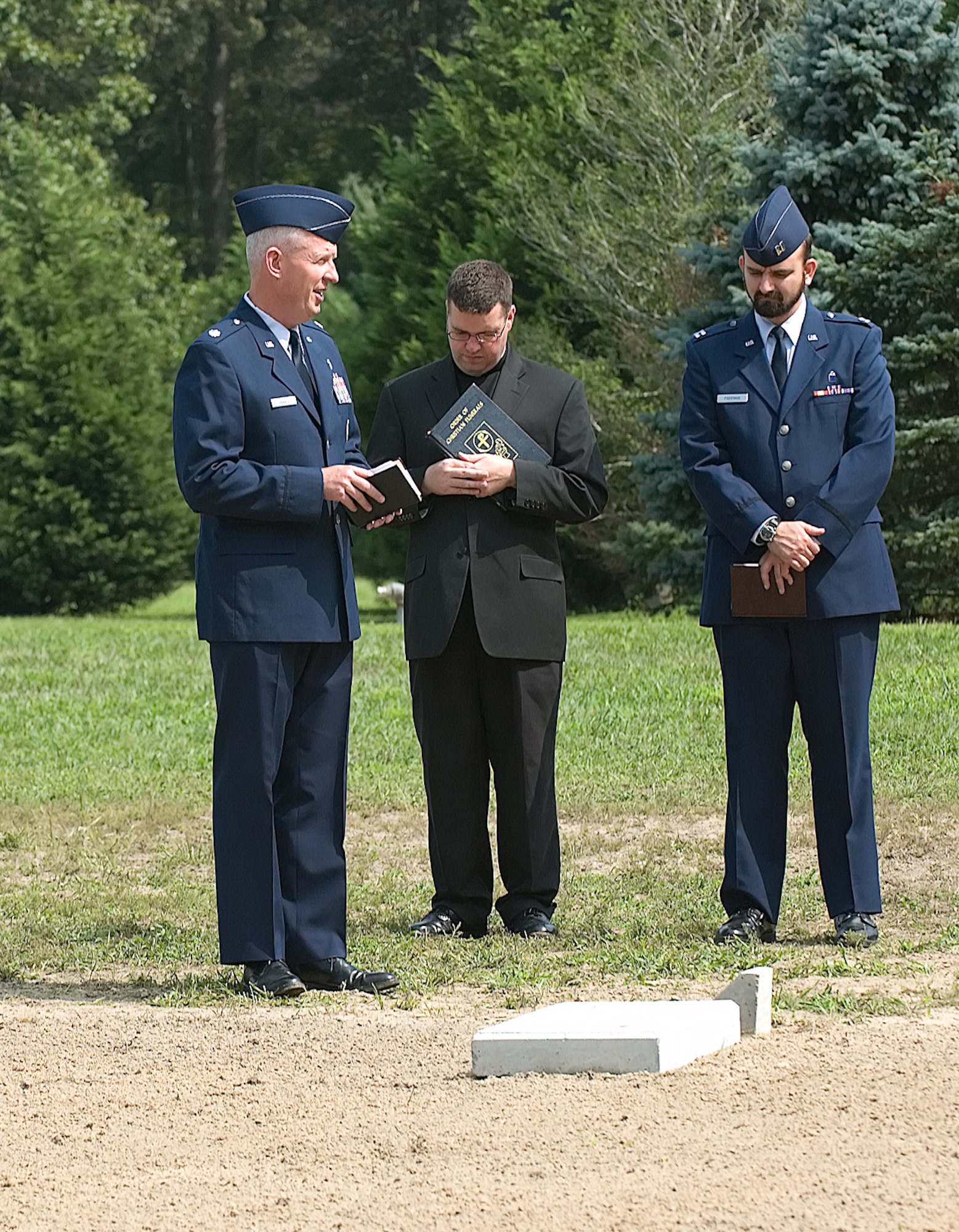 Chaplain (Lt. Col.) Ronald Harvell, 436th Airlift Wing chief chaplain, Chaplain (Capt.) Robert Roffman, an individual mobilization augmentee assigned to the 436th AW, and Father Michael Darcy, assistant pastor of Saint Ann’s Catholic Parish, Bethany Beach, Del., provided Protestant, Jewish and Catholic prayers, respectively, at a ceremony to repatriate 54 deceased Americans in Millsboro Aug. 24. (U.S. Air Force photo/Jason Minto)