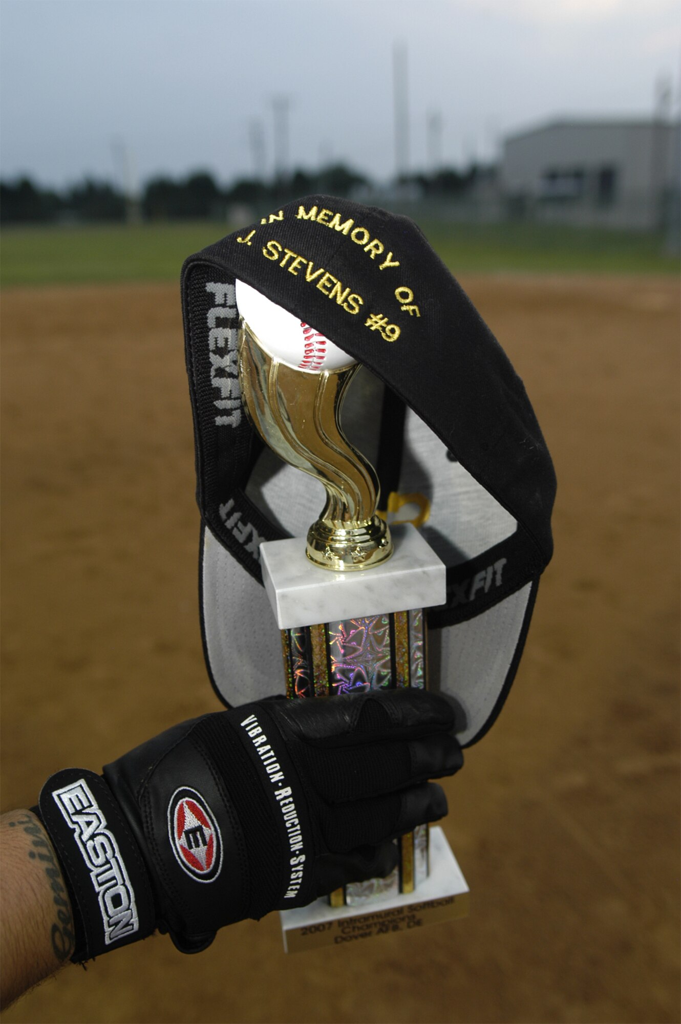 To honor thier fallen teammate, the 436th Security Forces Squadron softball team embroidered the backs of their caps with ‘In memory of J. Stevens #9.’ (U.S. Air Force photo illustration/Airman Shen-Chia Chu and Tech. Sgt. Kevin Wallace)