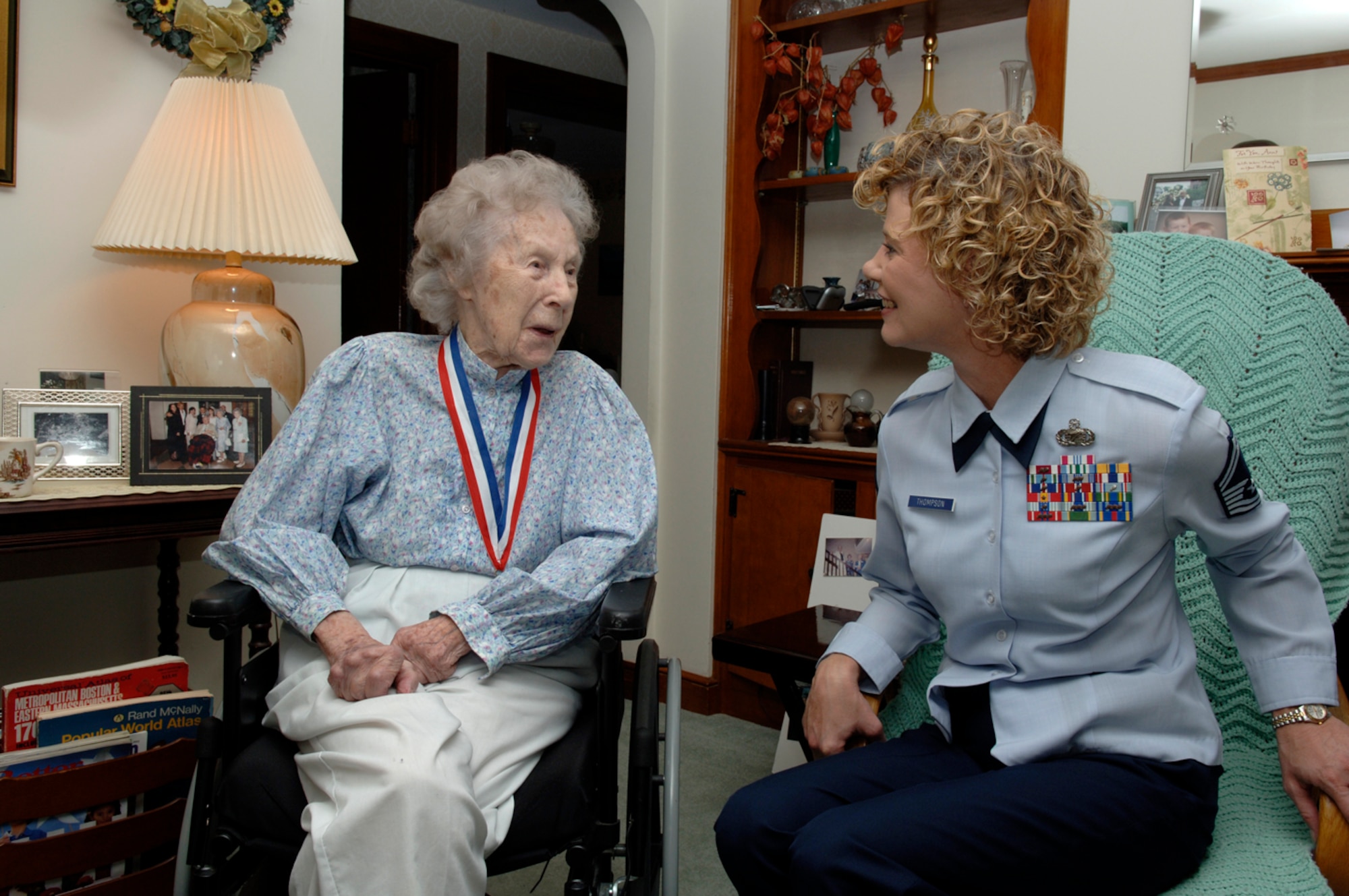 HANSCOM AFB, Mass. -- Retired Chief Master Sgt. Esther MacKay shares a laugh with Senior Master Sgt. Ginger Thompson, 66th Medical Group superintendent, Aug. 29 in the chief's home in Needham, Mass. 

Chief MacKay was recently appointed an Honorary Charter Chief, a title bestowed upon her by the Charter Chief's Group. The Charter Chief's Group was formed by the first group of men who were promoted to chief master sergeant in 1959. Chief MacKay is the third woman to be appointed an Honorary Charter Chief. 

A group of Hanscom enlisted leaders, inlcuding Sergeant Thompson, visited Chief MacKay's home to personally present her with a plaque and medallion on behalf of the Charter Chief's Group. Sergeant Thompson is Hanscom's newest Chief select and will promote to the rank of chief master sergeant later this year.

Chief MacKay, served in the Armed Forces from 1943 to 1965. At 102 years old, Chief MacKay is the Air Force’s oldest chief master sergeant. (U.S. Air Force photo by Walter Santos)