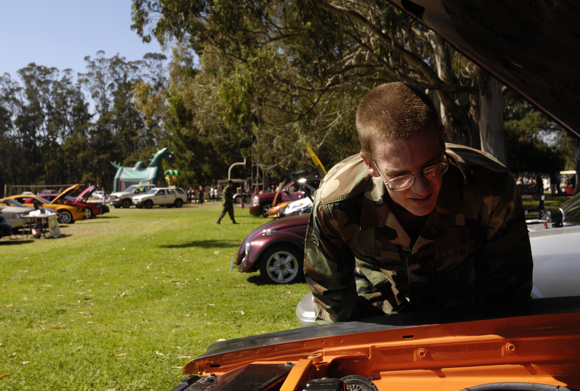 VANDENBERG AIR FORCE BASE, Calif. -- Airman 1st Class Ryan Dane, 30 Medical Operations Squadron, admires the vehicles on display during the Texas Blowout Barbecue on Aug. 24. The event raised more than $18,000 for the 48th annual Operation Kids Christmas event, a celebration which provides more than 200 under privileged children with Christmas presents and a holiday dinner gift certificate. (U.S. Air Force photo/Airman 1st Class Christian Thomas)