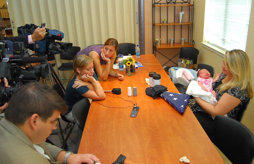 Michelle Ritter holds her newborn daughter, Meagan Marie, as she talks to her husband Tech. Sgt. Joseph Ritter, 23rd Civil Engineer Squadron heavy equipment craftsman, on the phone during a press conference at Smith Northview Hospital in Valdosta Ga. Aug. 28. Sergeant Ritter is currently on a deployment at Camp Victory, Iraq. Meagan’s birth was broadcast to him live so he could participate. (U.S. Air Force photo by Tech. Sgt. Parker Gyokeres)