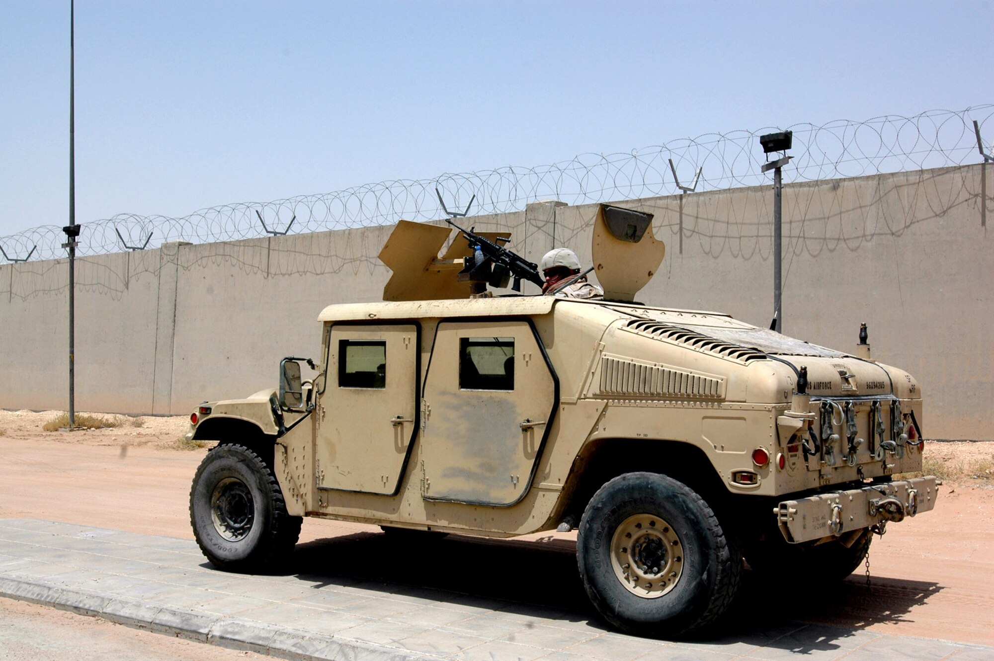 A security forces Airman with the 64th Air Expeditionary Group stands watch over fellow Airmen as they infiltrate a building during an exercise Aug. 20 in Southwest Asia. (U.S. Air Force photo/Capt. Teresa Sullivan) 

