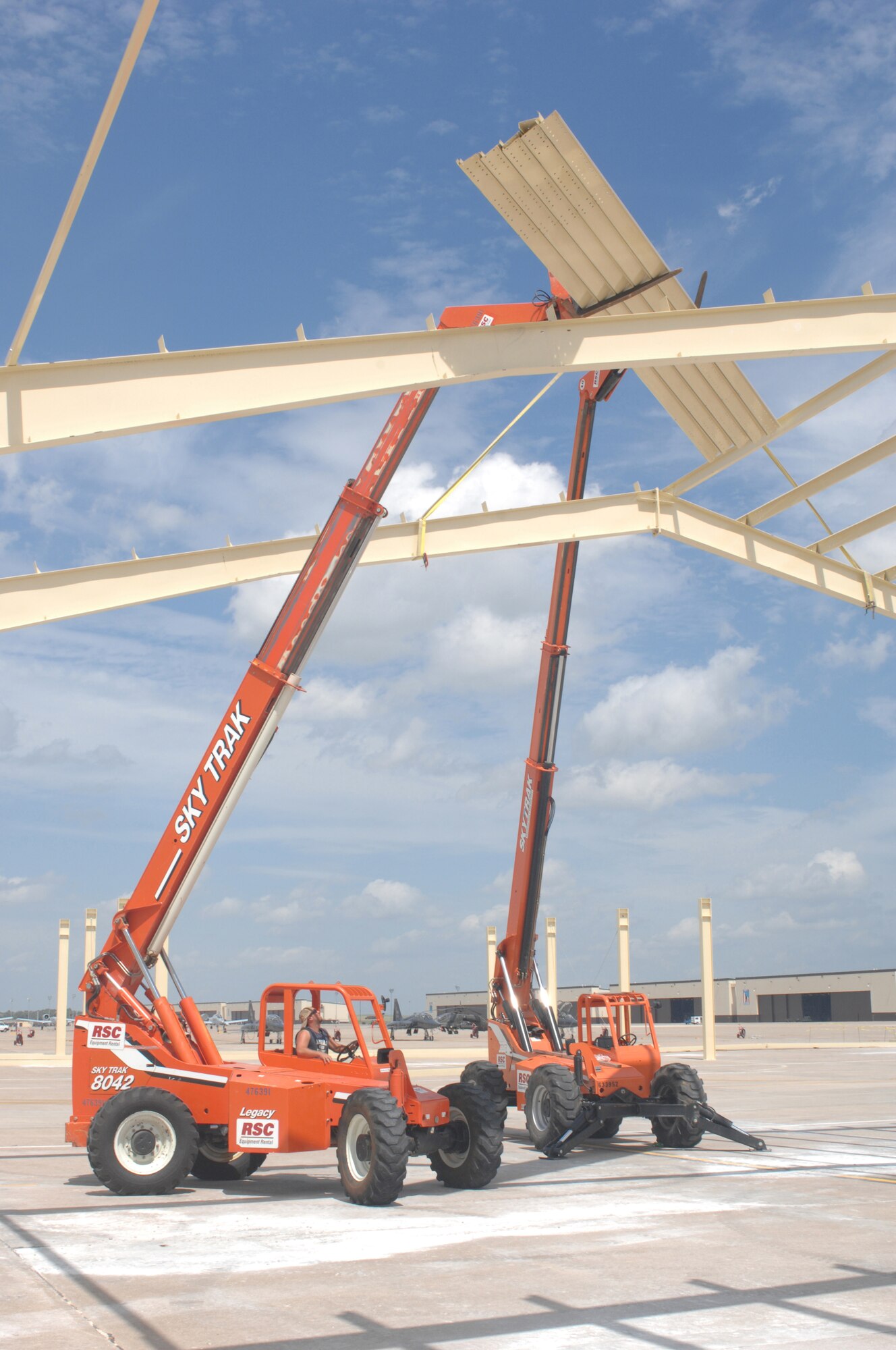 WHITEMAN AIR FORCE BASE, Mo., -- John Baggett, EDL Contracting Company, lifts the purlins onto the frame with a telescoping forklift. Shelters are being constructed for the 442nd Fighter Wing's A-10s between the A-10 maintenance hangers and the 509th Bomb Wing B-2 docks. Due to the 2005 realignment, whiteman had an increase of aircraft it did not have enough hanger space for. The shelters will be used for maintenance on the A-10’s during increment weather. (U.S. Air Force Photo/Tech Sgt. Samuel Park)