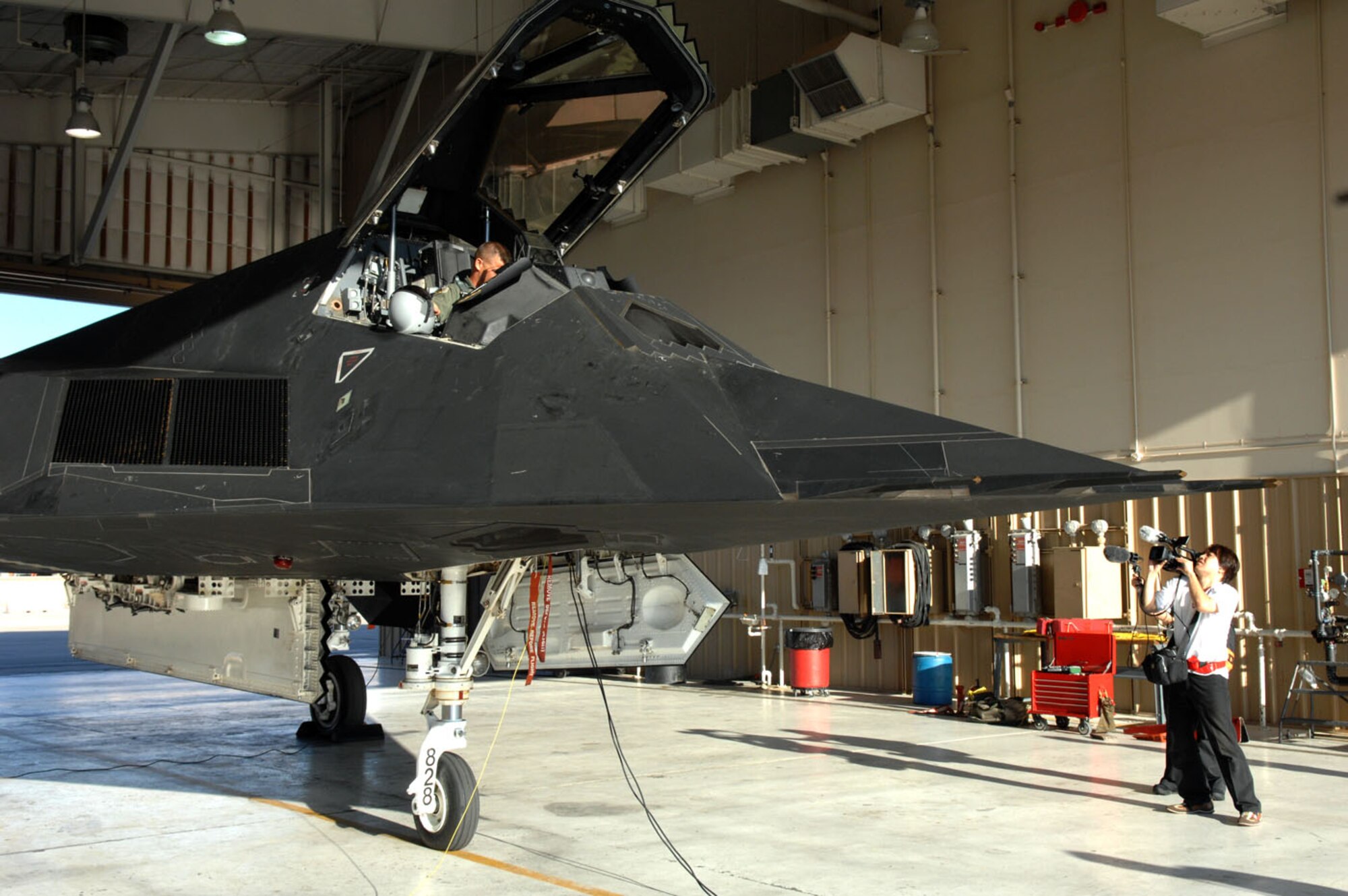 A Japanese news crew documents the F-117A Nighthawk as a tribute to its retirement and history. (U.S. Air Force photo/Senior Airman Anthony Nelson)