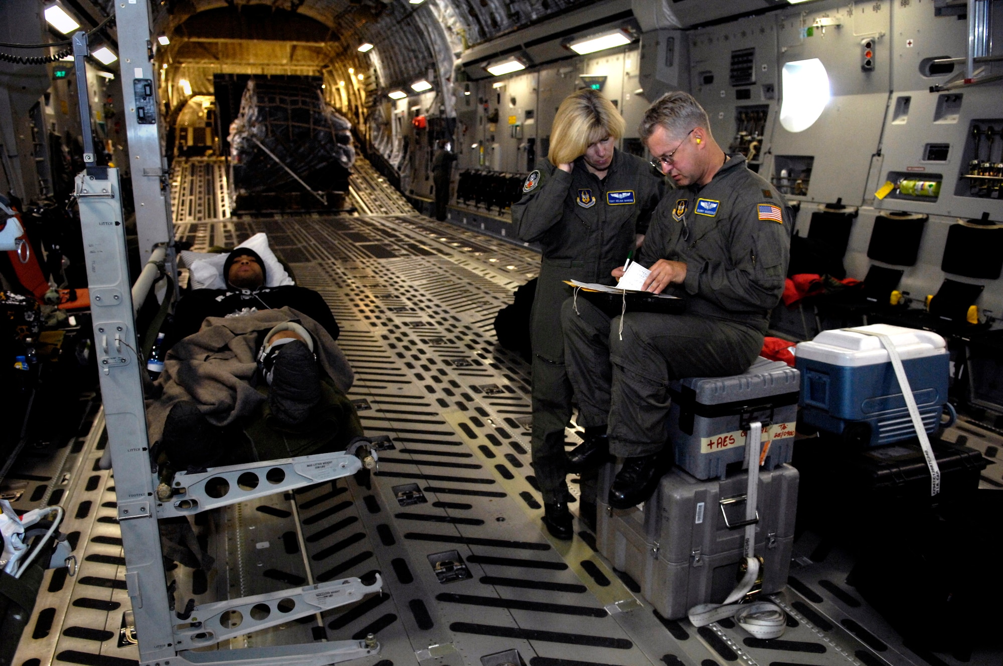 Tech. Sgt. Selina Barone and Maj. Berry Vansickle look over patient paperwork on board a C-17 Globemaster III medical evacuation flight Aug. 28 from Antarctica. The Airmen are from the 446th Aeromedical Evacuation Squadron from McChord Air Force Base, Wash. The medical evacuation mission was flown for a patient who required more definitive medical treatment than can be handled in Antarctica. (U.S. Air Force photo/Tech. Sgt. Shane A. Cuomo) 
