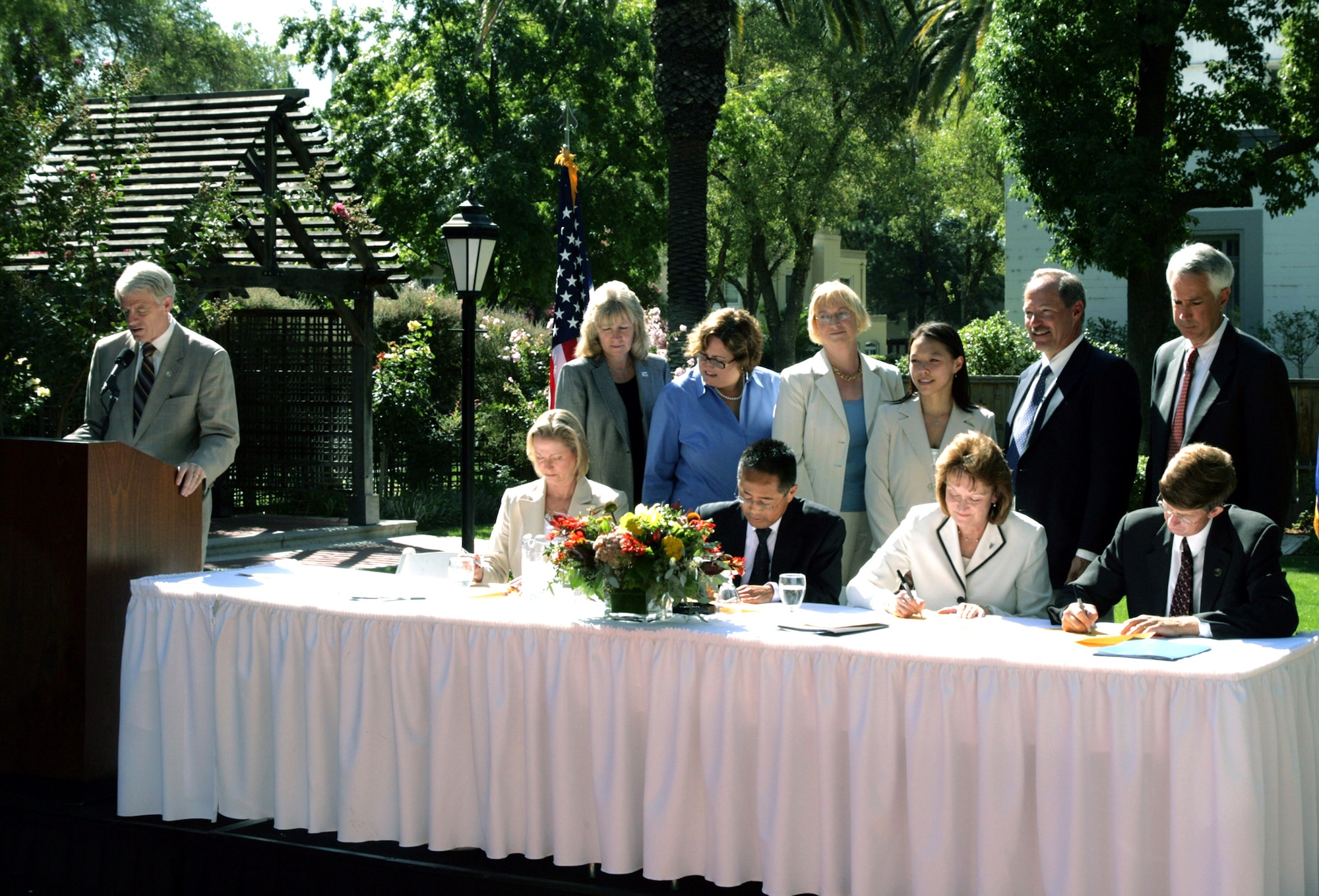 Sacramento County Supervisor Roger Dickinson (left) reads the ceremonial scroll Aug. 27 at the former McClellan Air Force Base in California. The ceremony marked the first time in the nation the military funded an early transfer with privatized remediation at a National Priority List site. Copies of the scroll are signed by (from left, front row): Linda Adams of the California Environmental Protection Agency, Kieth Takata, EPA Region 9, Kathryn Halvorson of the Air Force Real Property Agency, Don Nottoli of the Sacramento County Board of Supervisors, and (from left, back row): Pamela Creedon of the California Regional Water Quality Control Board, Maureen Gorsen of the California Department of Toxic Substances Control, Kathleen Johnson and Yvonne Fong of the EPA Region 9, Phil Mook of the  AFRPA, and Rob Leonard of the Sacramento Department of Economic Development. (U.S. Air Force photo) 
