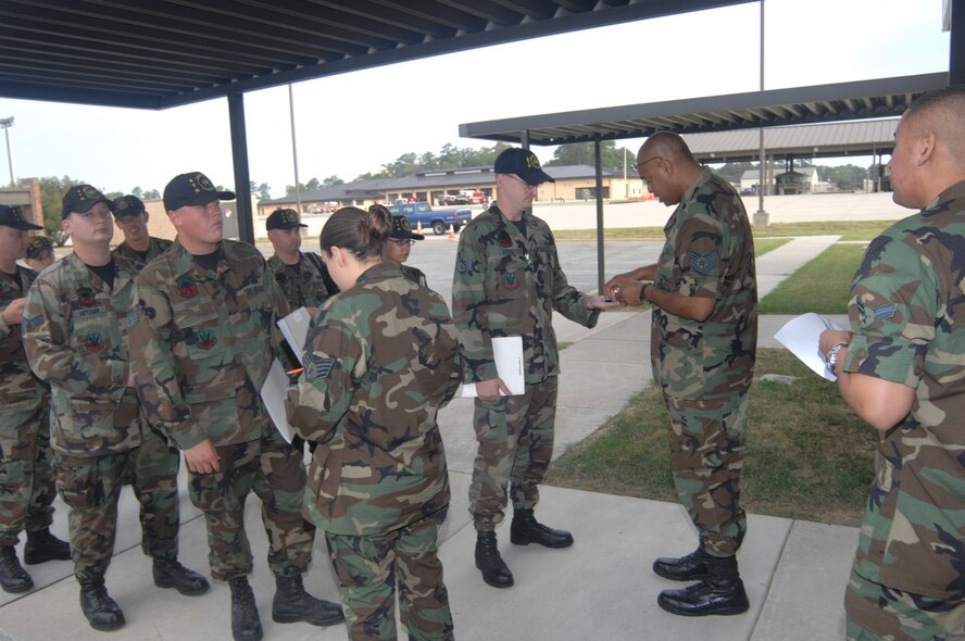 SEYMOUR JOHNSON AIR FORCE BASE, N.C. - Tech. Sgt. Wayne Powell and Staff Sgt. Erica Tavai, both 4th Mission Support Squadron, check dogs tags from Airmen in the 4th Fighter Wing to make sure that their information is correct before deployment, during processing at Seymour Johnson Air Force Base Aug. 29, 2007. More than 600 4th FW Airmen will deploy in the next few months. (U.S. Air Force photo by Senior Airman Chad Trujillo) 