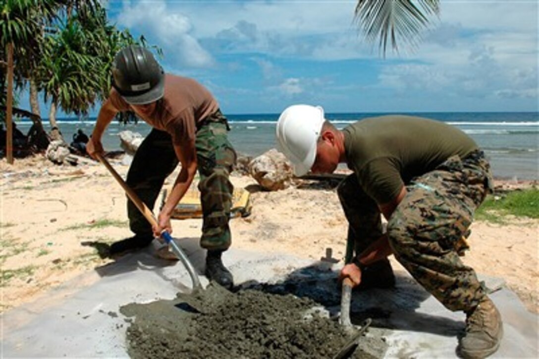 Sailors from Naval Mobile Construction Battalion Seven mix cement for a fence post during an engineering civil-assistance program at Delap Elementary School in Majuro, Marshall Islands, Aug. 29, 2007, in support of Pacific Partnership. 