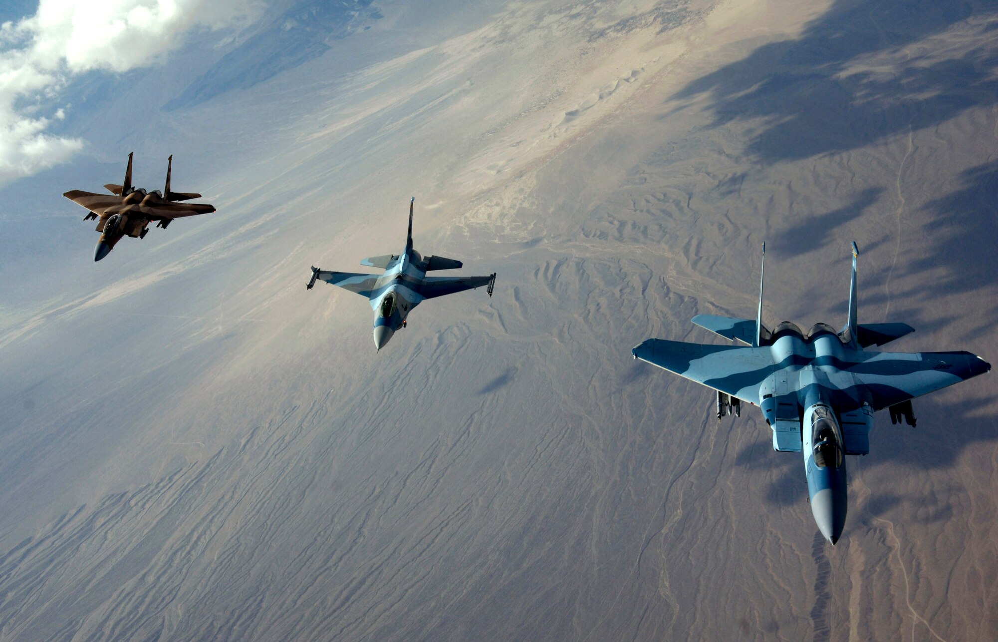 The 64th Aggressor Squadron's F-15 Eagles and F-16 Fighting Falcon head to the fight after refueling Aug. 28 during Red Flag 07-3 exercise at Nellis Air Force Base, Nev. Red Flag tests aircrew war-fighting skills in realistic combat situations. The aircraft fly missions during the day and night to the nearby Nevada Test and Training Range to simulate an air war. Servicemembers from all the U.S. military branches, along with coalition forces, are participating in the event. (U.S. Air Force photo/Master Sgt. Kevin J. Gruenwald)