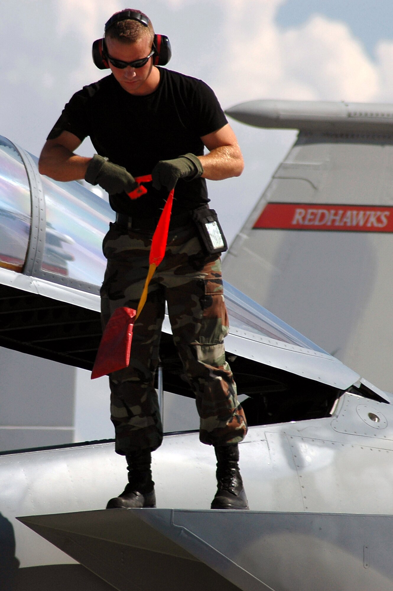 Crew chief Staff Sgt Adam Pattison pulls pre-flight safety pins on an F-15 Eagle during the Red Flag 07-3 exercise Aug. 28 at Nellis Air Force Base, Nev. Servicemembers from all the U.S. military branches, along with coalition forces, are participating in the event. Sergeant Pattison is an Air National Guard member assigned to the 142nd Fighter Wing at Portland, Ore. (U.S. Air Force photo/Tech. Sgt. Bob Sommer)
