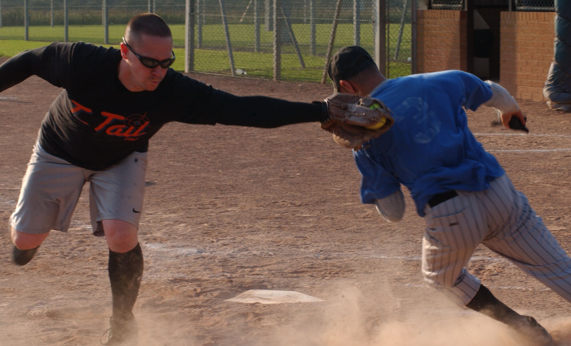 A member the 100th Operation Group, Alex Pisaturo slides into home while 727th Air Mobility Squadron catcher, Christopher Jackson, tries tag him out in the 2007 RAF Mildenhall softball intramural semi-final championship game between the 727th AMS and the 100th OG, Aug. 29, 2007, at RAF Lakenheath. (U.S Air Force photo By Airman Brad Smith)