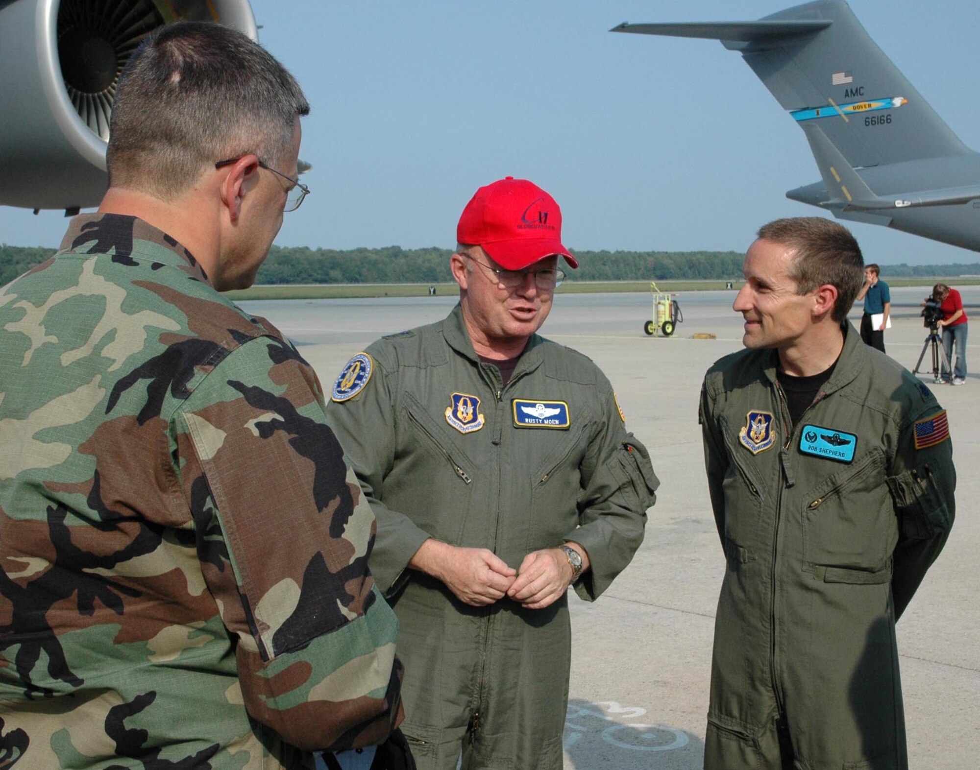 DOVER AIR FORCE BASE, Del. -- Col. Randal L. Bright, 512th Airlift Wing commander, left, and Lt. Col. Rob Shepherd, 326th Airlift Squadron commander, right, welcome Maj. Gen. Hanferd "Rusty" J. Moen Jr., the director of Intelligence, Air, Space and Information Operations for Air Force Reserve Command at Robins Air Force Base, Ga., to Dover Air Force Base, Del. General Moen delivered Dover AFB's fourth C-17 during a delivery ceremony Thursday afternoon. The base is scheduled to receive 13 C-17s by the end of 2008. (U.S. Air Force photo/Capt. Marnee A.C. Losurdo)
