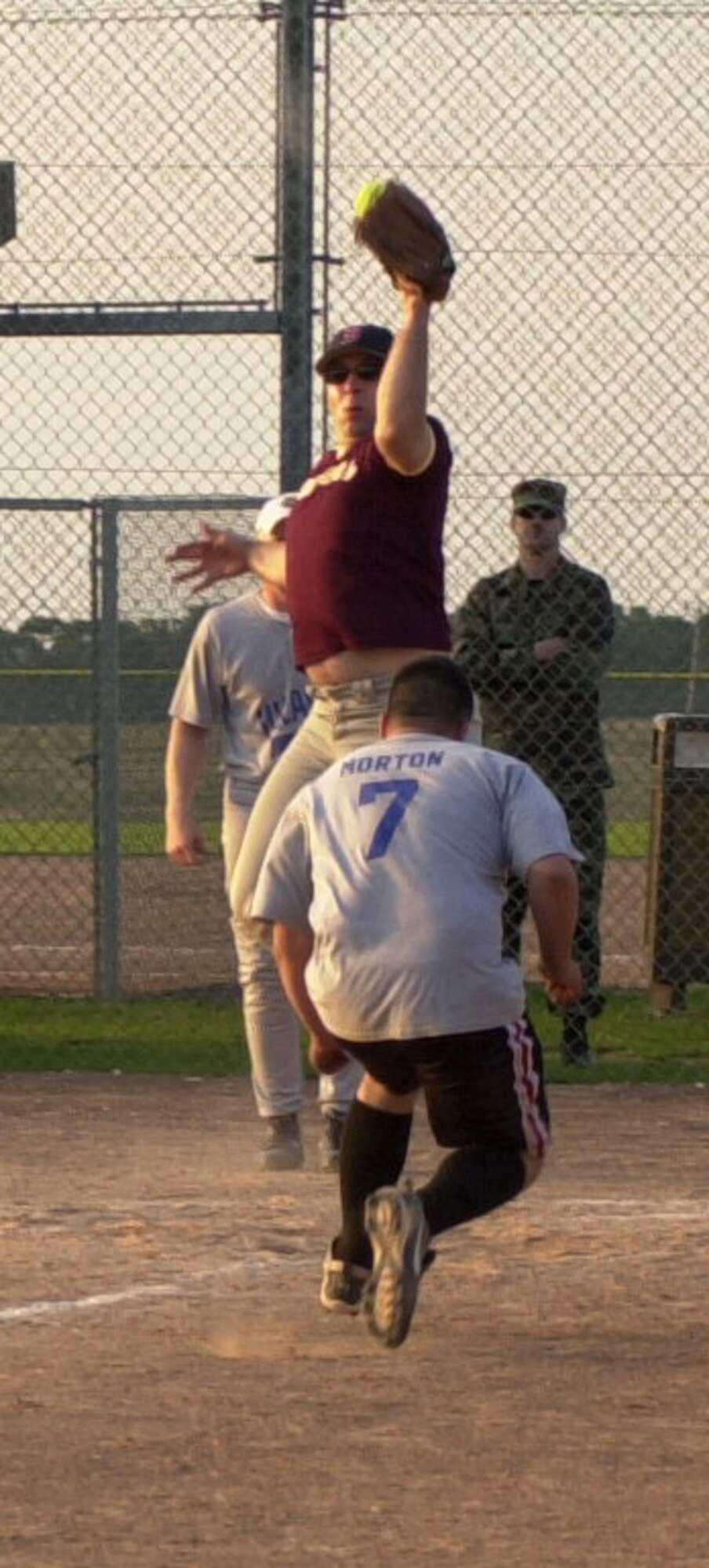 From the 100th Operation Group, third baseman Jason Morton runs into home base while 352nd Maintenance Squadron catcher Christopher Mercier tries to tag him out during the RAF Mildenhall softball championship game, Aug. 29, 2007, at RAF Lakenheath. (U.S Air Force by Gary Rogers)