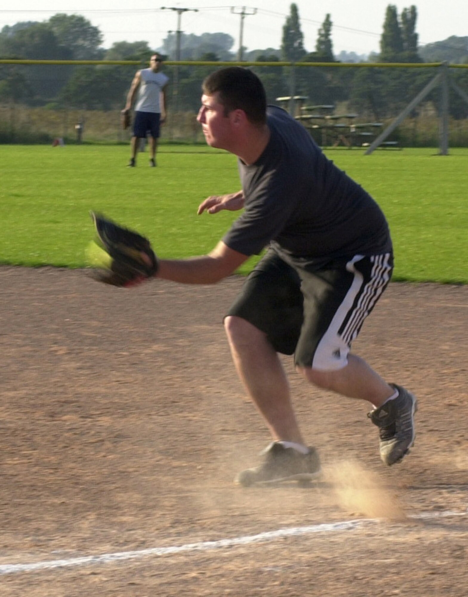 Matthew Ashmore, from the 352nd Maintenance Squadron, catches a grounder during the 2007 RAF Mildenhall softball intramural semi-final game against the 100th Civil Engineering Squadron Team, Aug. 29, 2007, at RAF Lakenheath. (Air Force photo By Gary Rogers)