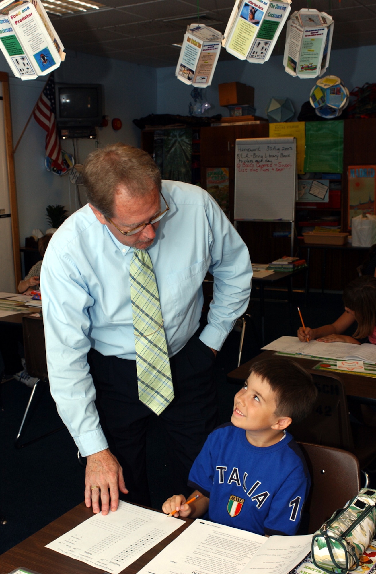 Fourth-grader Alex Laurel smiles up at Mr. Fletcher, Lakenheath Intermediate School principal, as he receives some test-taking pointers. (U.S. Air Force photo by Airman 1st Class Torri Ingalsbe)