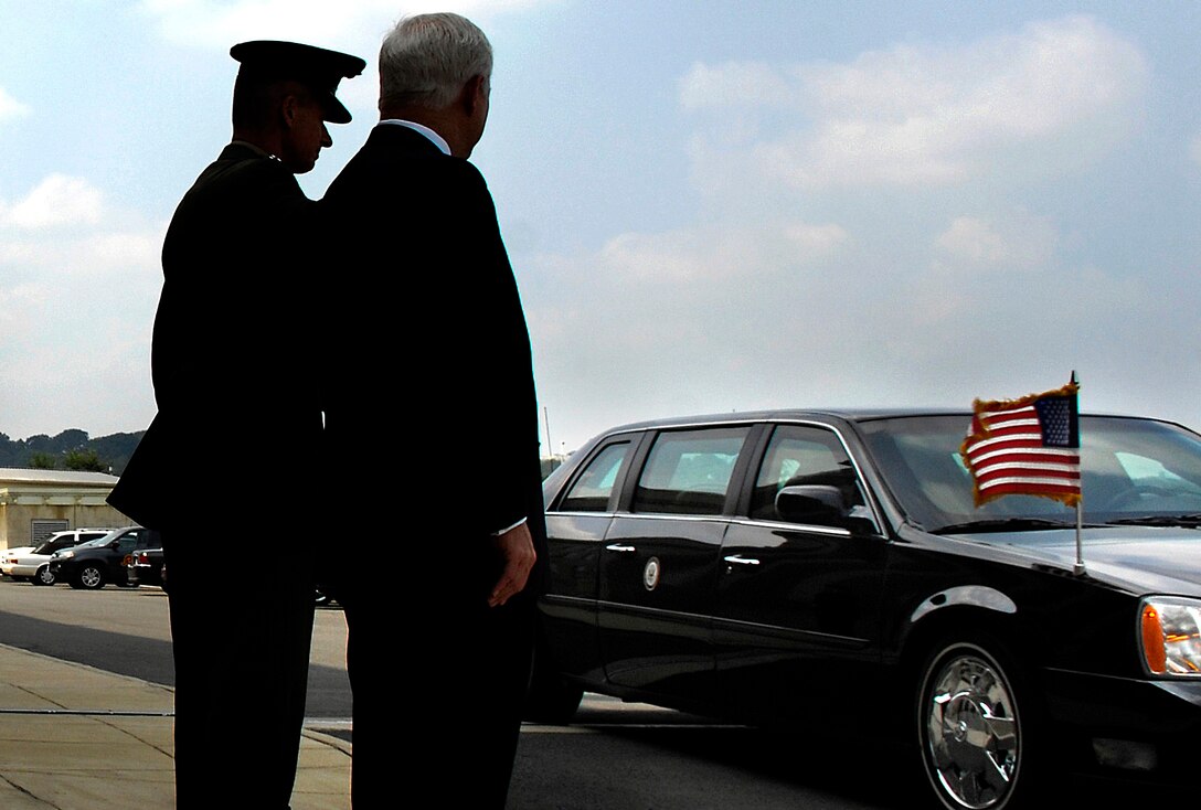 Marine Gen. Peter Pace (left), chairman of the Joint Chiefs of Staff, and Secretary of Defense Robert M. Gates, await the arrival of President Bush and Vice President Cheney as their limousine arrives at the Pentagon, Aug. 31, 2007. 