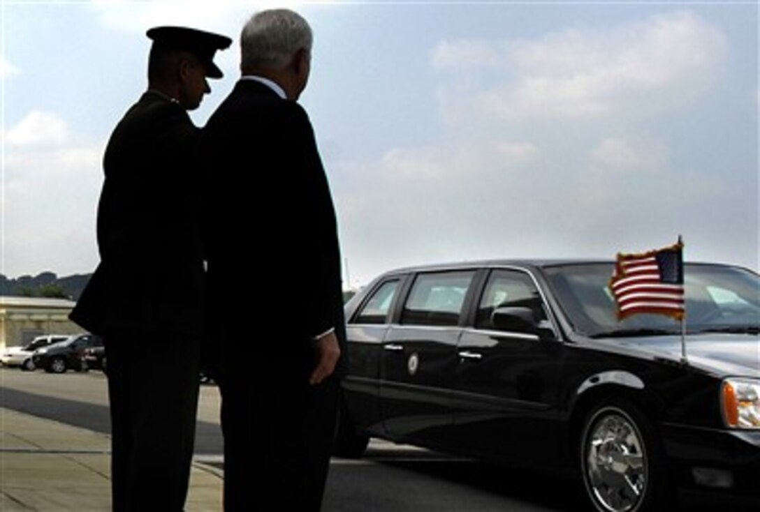 Marine Gen. Peter Pace, left, chairman of the Joint Chiefs of Staff, and Secretary of Defense Robert M. Gates, await the arrival of President Bush and Vice President Cheney as their limousine arrives at the Pentagon, Aug. 31, 2007. 