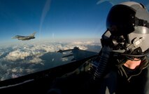 KUNSAN AIR BASE, South Korea-- F-16 Fighting Falcons from the 80th Fighter Squadron join up for a post-mission safety check before returning to base Nov. 29.  The aircraft were part of a close-air-support training mission over South Korea.  (U.S. Air Force Photo/Master Sgt Jack Braden)