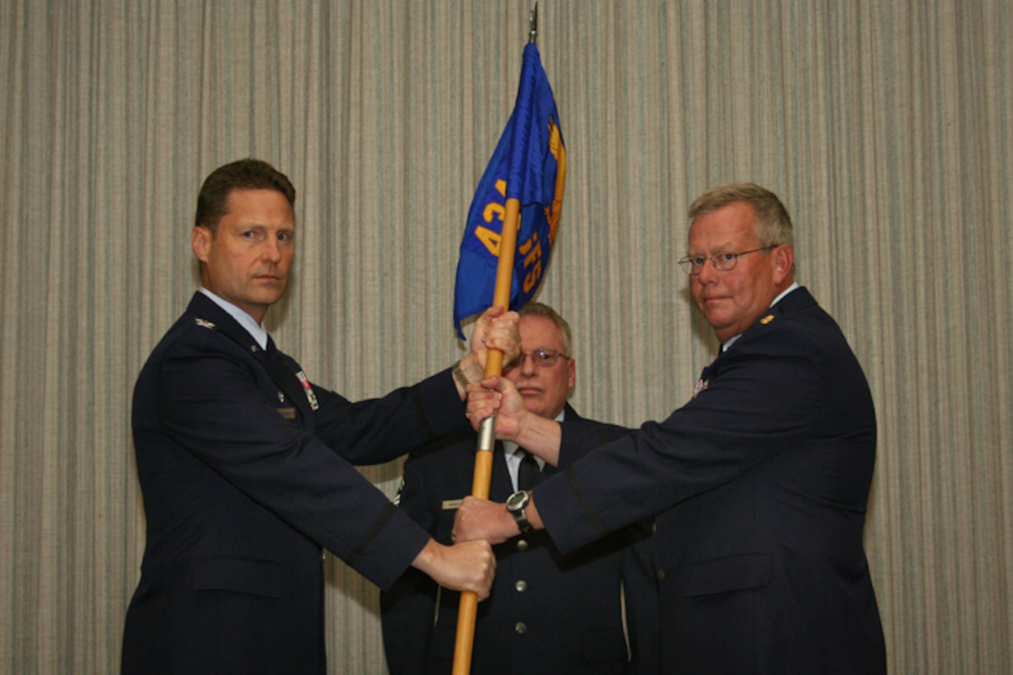 GRISSOM AIR RESERVE BASE, Ind -- Maj Randy Stivers (right) accepts the 434th Security Forces Squadron flag from Col. Doug McHugh, 434th Mission Support Group commander, during a change of command ceremony.  Major Stivers is the new commander of the 434th SFS, replacing Lt. Col. Phil Shott who moves into the 434th Mission Support Group deputy commander position.  (U.S. Air Force photo/TSgt Patrick Kuminecz)