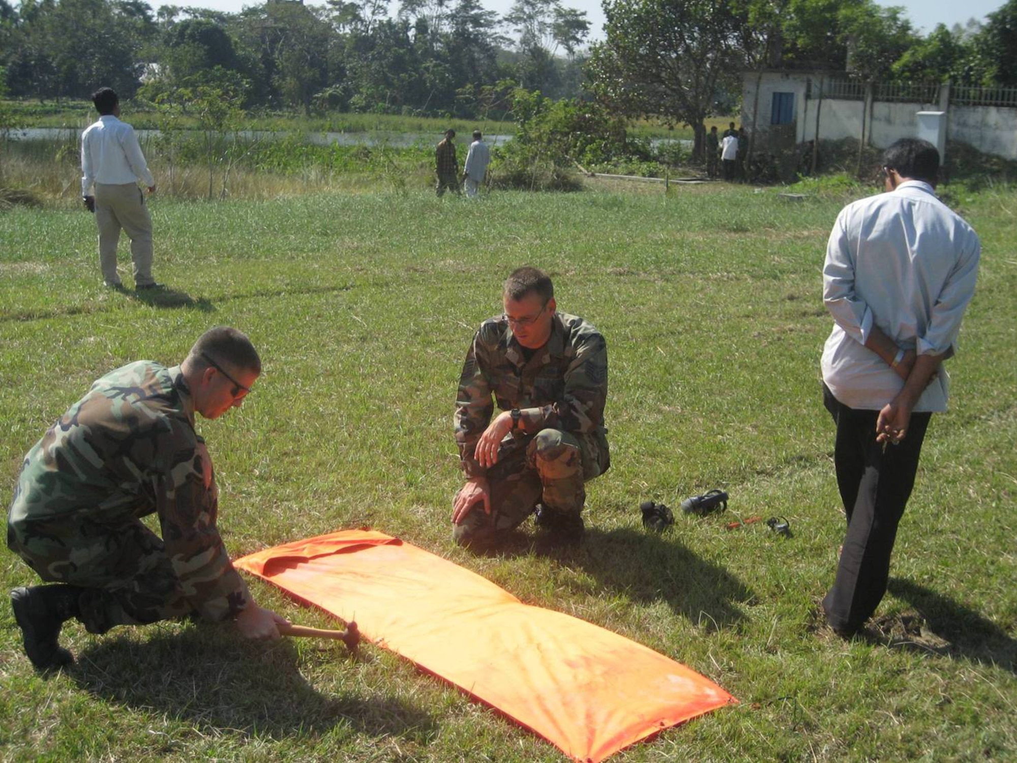 Master Sgt. Jon Harston and Tech. Sgt. Timothy Galunas mark a helicopter landing site.  The four additional helicopter landing sites increased the amount of aircraft the airfield could handle. (Courtesy photo)