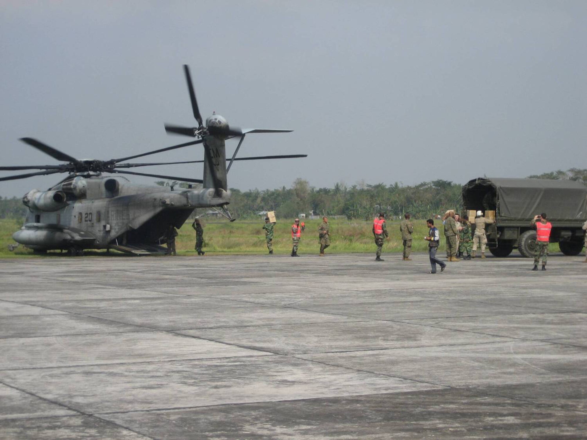 Technical Sergeants James Glickman, Timothy Galunas, and Leslie Vanbelkum control the trans-load of supplies on to a CH-53. (Courtesy photo)