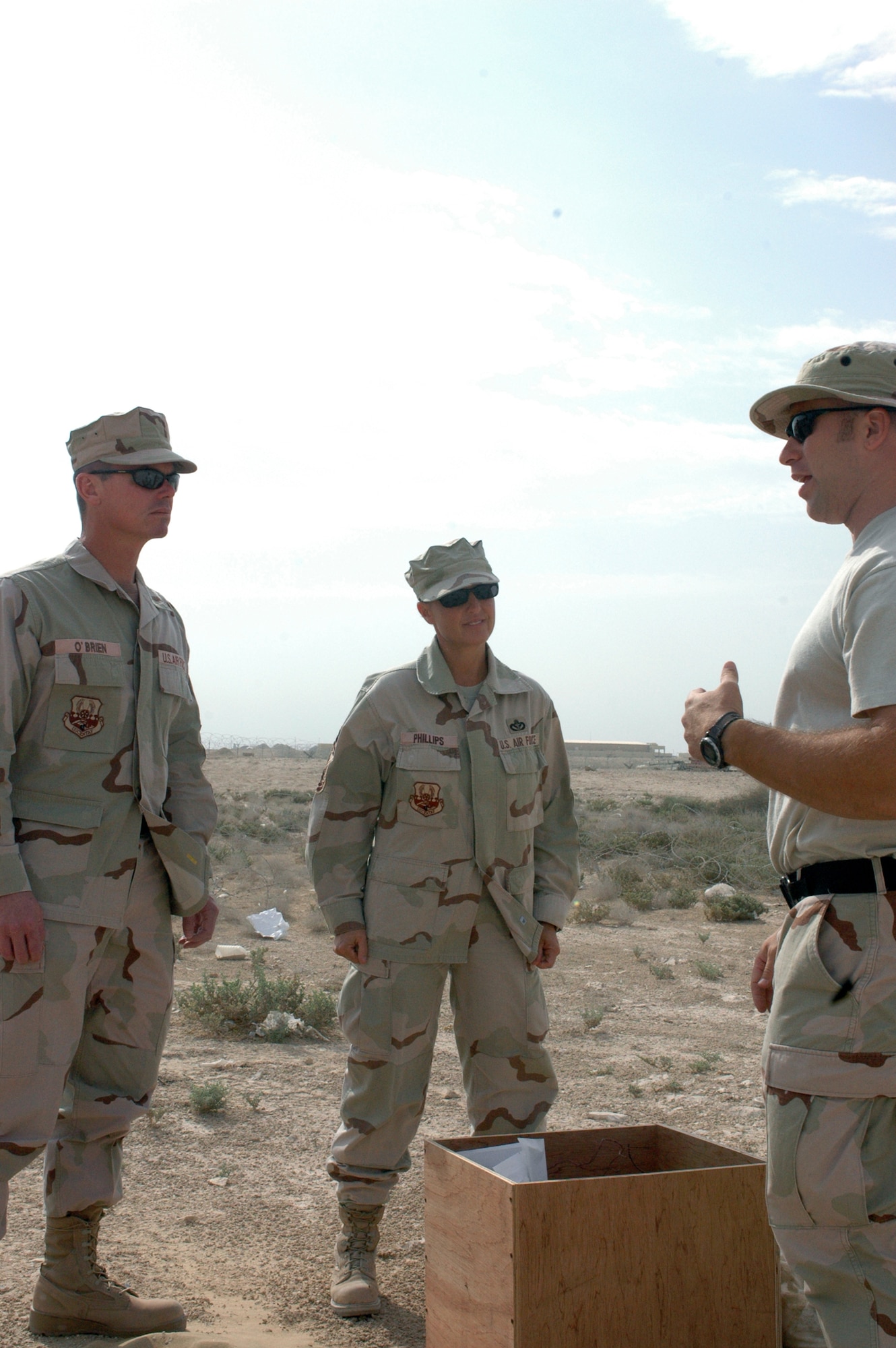 SOUTHWEST ASIA - Chief Master Sgts. John O?Brien (left) and Suzanne Phillips (center), 379th Expeditionary Civil Engineer Squadron, are briefed by Tech. Sgt. David Fitzgerald (right), 379th ECES, Explosive Ordinance Disposal, about how EOD performs their duties and what their mission here is. Chief O?Brien is the incoming and Chief Phillips is the outgoing 379th ECES Chief. (U.S. Air Force photo/Staff Sgt. Jason Barebo)