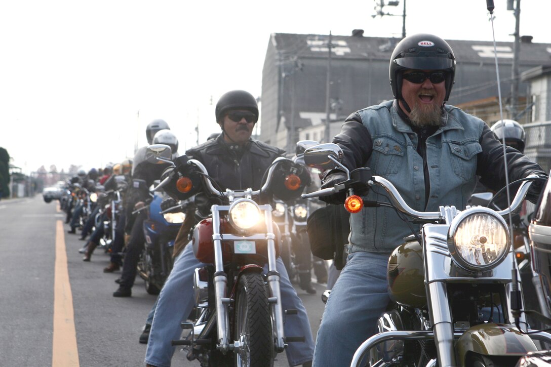 Paul S. Hudson, station environmental trainer and native of Odessa, Texas, leads a pack of motorcyclists through the streets of the air station in support of the 60th annual Toys for Tots campaign at the Hornet?s Nest here Dec. 2. The event collects and distributes toys for needy youngsters in the local community.