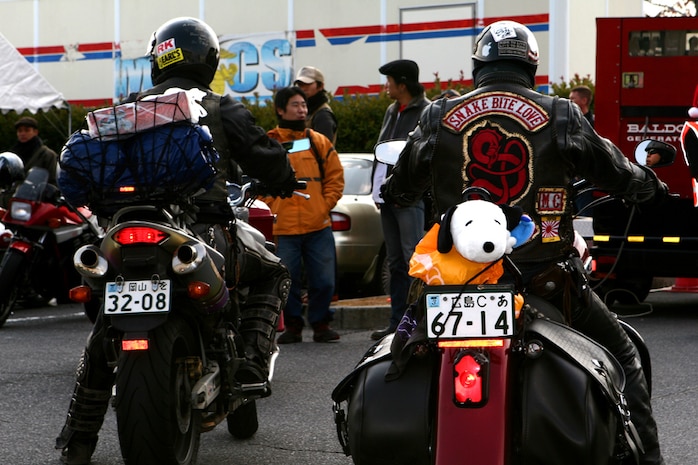 Motorcyclists from Iwakuni City arrive at the Hornet?s Nest here Dec. 2, bearing gifts for the 60th Toys for Tots campaign, an annual event that collects and distributes toys for needy youngsters in the local community.