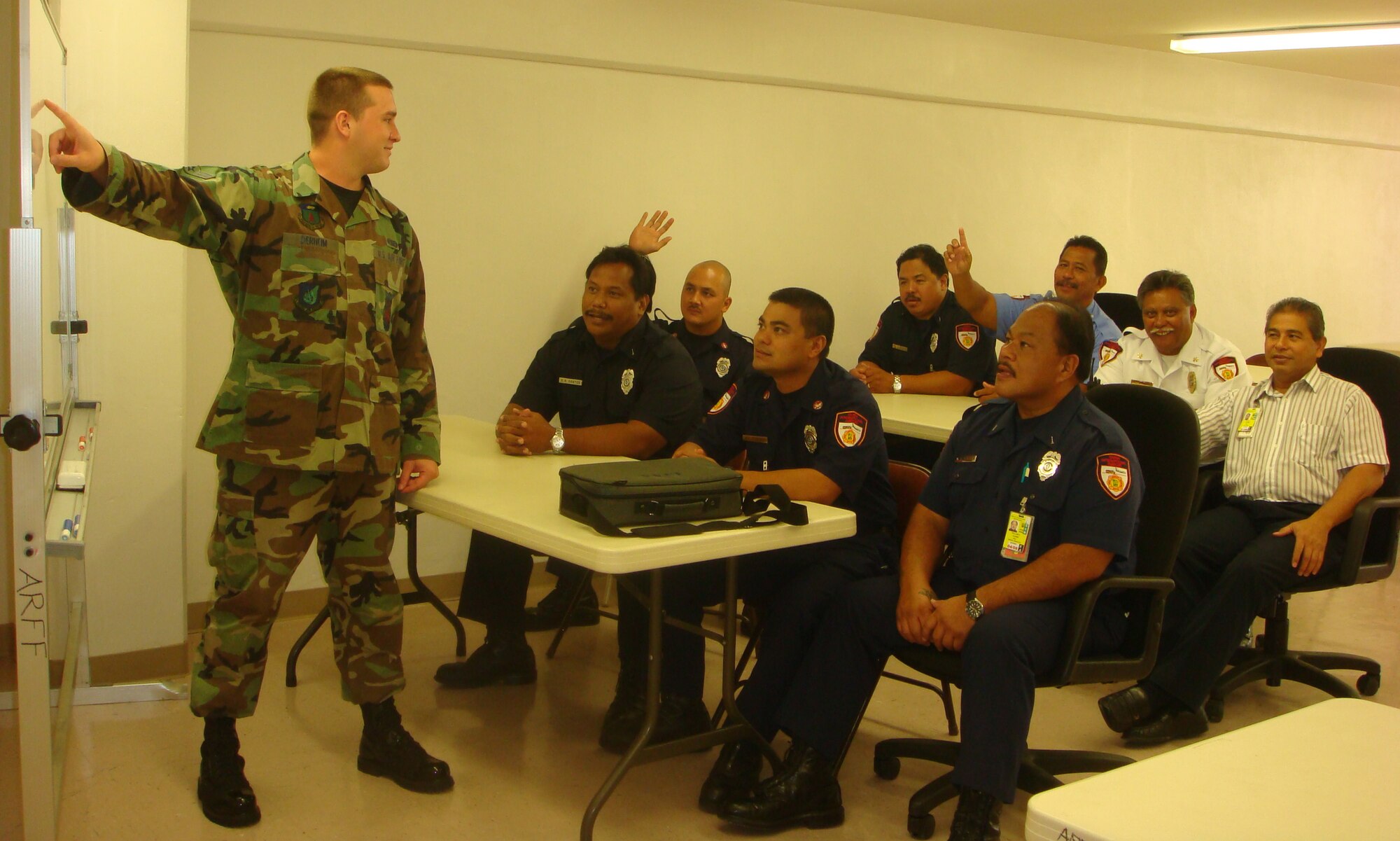 Airman 1st Class Matthew Derheim, 36th Civil Engineer Squadron fire department, shares his knowledge and expertise in egress, shutdown procedures and aircraft firefighting operations to Guam Aircraft Rescue and Fire Fighting members. (U.S. Air Force photo/Staff Sgt. Francis Tagalog) 
