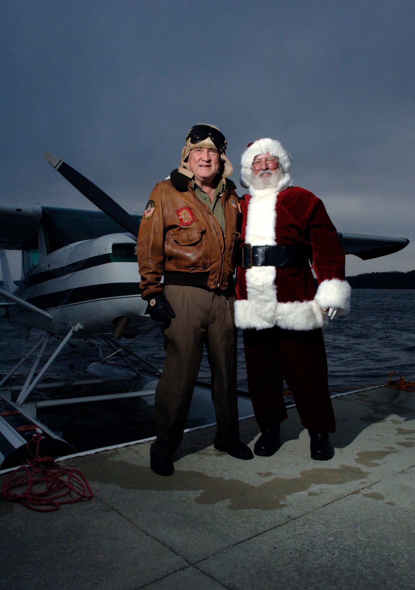 Santa Claus stands with Dr. William Freeman, a retired Air Force flight surgeon and F-4 Phantom II pilot, in front of the doctor's amphibian Cessna aircraft.  Dr. Freeman flew Santa to Arnold Air Force Base, Tenn., Dec. 2 for a Christmas party on the base.  (U.S. Air Force photo/Staff Sgt. Bennie J. Davis III)