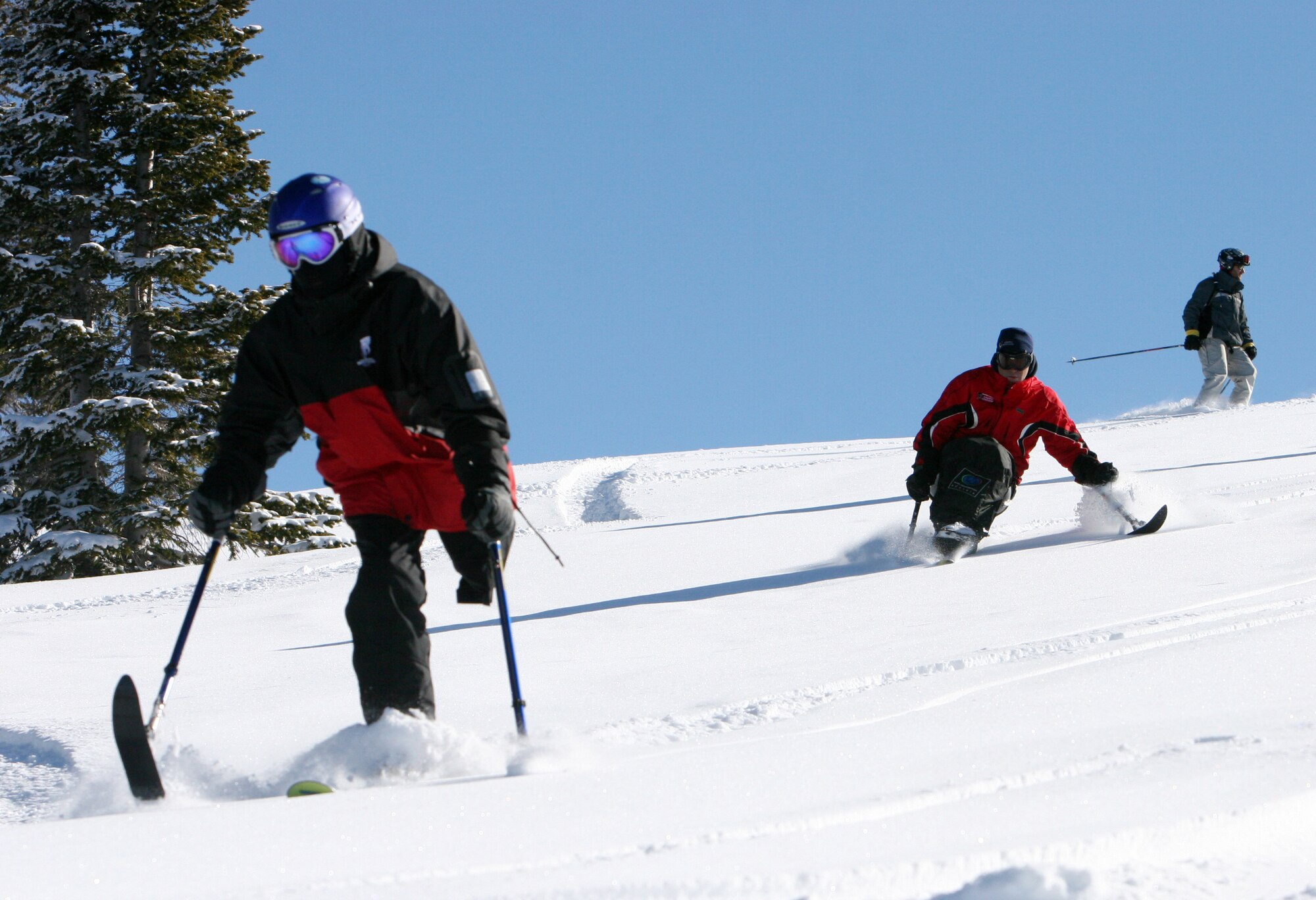 Ed Salau, followed by Adaptive Adventures program director Matt Feeney, carve some turns last winter at Steamboat. Wounded warriors, injured while fighting the Global War on Terrorism in Iraq or Afghanistan, will attend SnoFest this year and learn to ski within the limitations of their disabilities. (Courtesy photo)