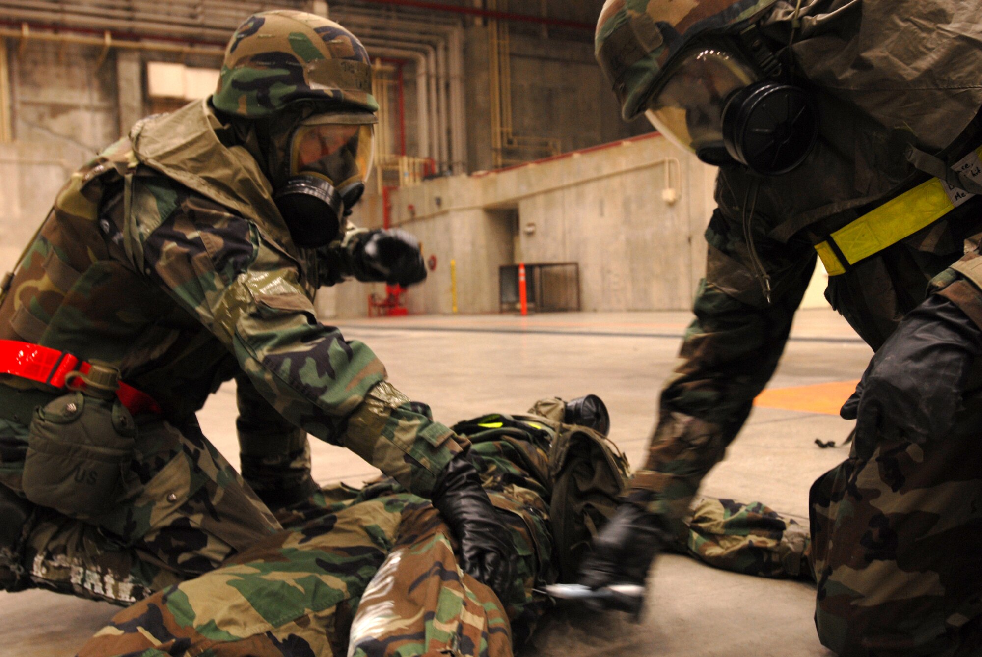 Tech. Sgt. Forest Sell and Senior Airman Victor Cross administer the Antidote Treatment Nerve Agent Auto-Injector to Senior Airman Tyler Willing in a scenario during Local Operational Readiness Exercise Beverly High 08-2 at Kadena Air Base, Japan, Dec. 4, 2007. These scenarios enable base agencies to work together, mitigate real-world situations, and heighten readiness capabilities. All Airmen are from the 718th Aircraft Maintenance Squadron 961st Aircraft Maintenance Unit. 
(U.S. Air Force photo/Staff Sgt. Chrissy FitzGerald) 
