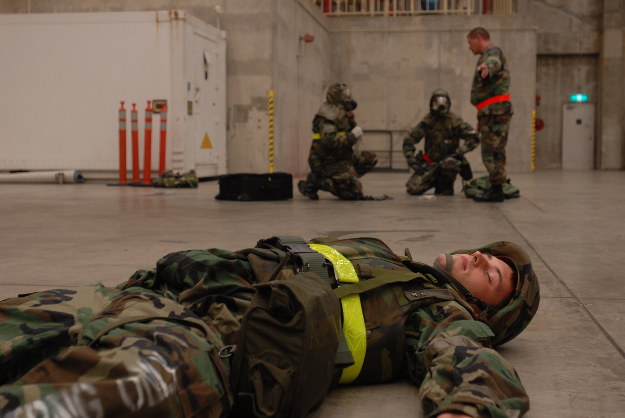 Senior Airman Tyler Willing lies and waits, while Senior Airman Victor Cross and Tech. Sgt Forest Sell receive their inject for the auto-injector scenario from Exercise Evaluation Member Master Sgt. Jefferson Baggett during Local Operational Readiness Exercise Beverly High 08-2 at Kadena Air Base, Japan, Dec. 4, 2007. These scenarios enable base agencies to work together, mitigate real-world situations, and heighten readiness capabilities.
(U.S. Air Force photo/Staff Sgt. Chrissy FitzGerald)

