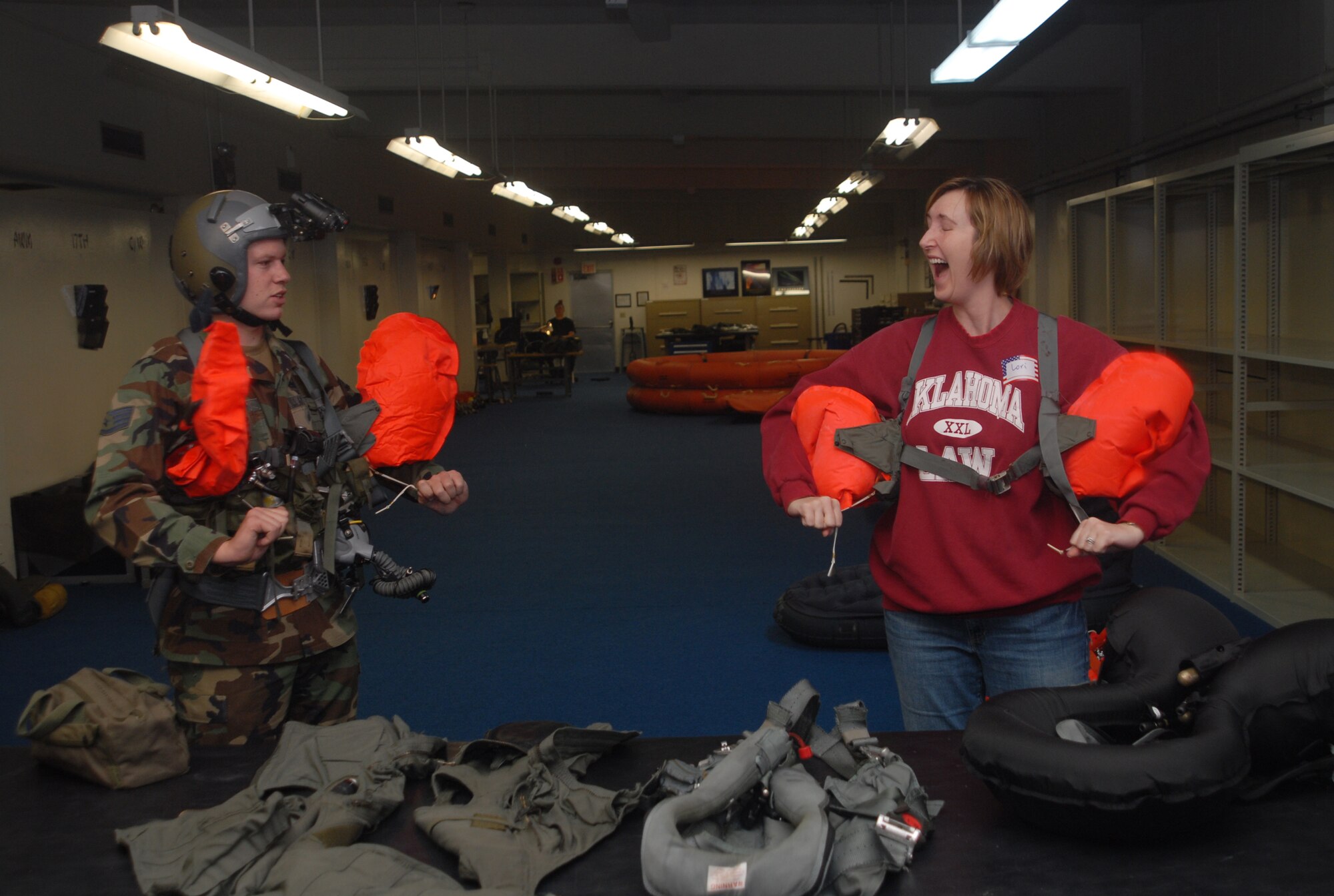 Lori Brown, wife of Gary Brown of the 18th Operations Support Squadron, tries out a floatation device as part of a tour of the unit Nov. 30, 2007. The squadron opened its doors to the spouses as a way of thanking them for their support.  (U.S. Air Force photo/Staff Sgt. Christopher A. Marasky)