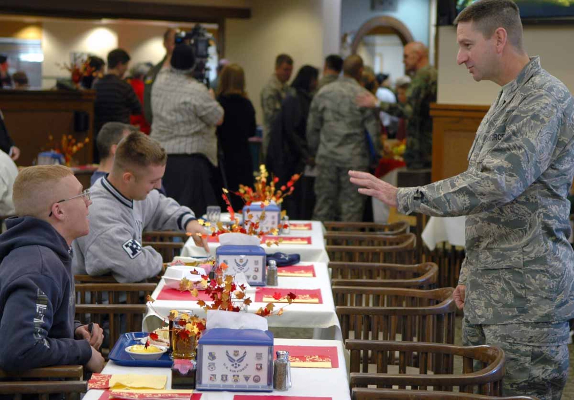 Col. Mark Correll, 72nd Air Base Wing commander, talks with Airmen at the annual Thanksgiving dinner at the Vanwey Dining Facility. For this year’s dinner, the Vanwey staff served more than 600 guests with 396 pounds of turkey, 240 pounds of steamship round, 45 pies, 10 cakes and gallons of green beans and corn.  (Air Force photo by Kathy Paine)