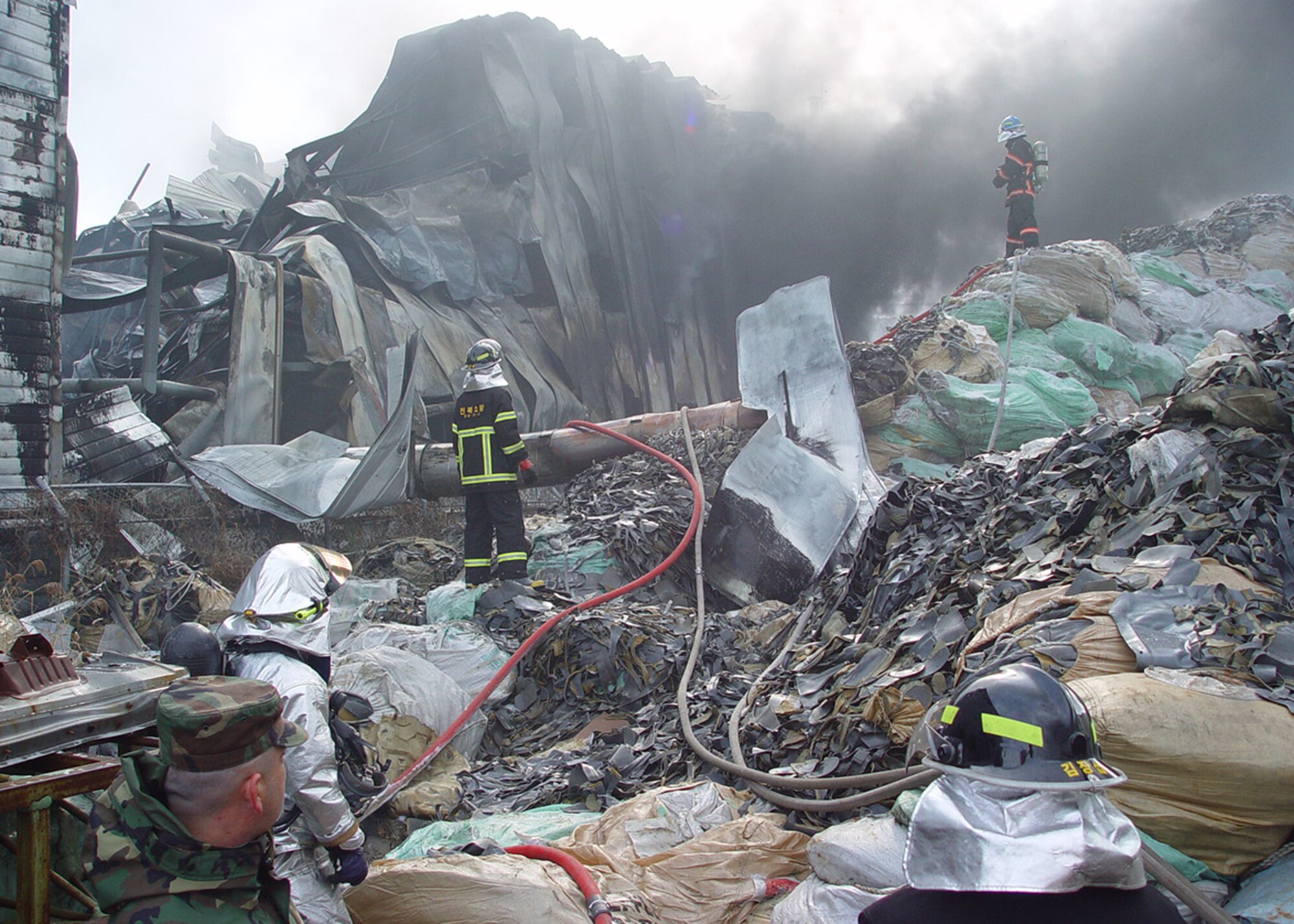 Gunsan City firefighters and 8th Civil Engineer Squadron firefighters diminished a fire here Dec. 3. Airmen from the 8th CES fire department, work together with local fire departments to put out a large industrial fire. (U.S. Air Force photo/Tech. Sgt. Jason Rosenbaum) 