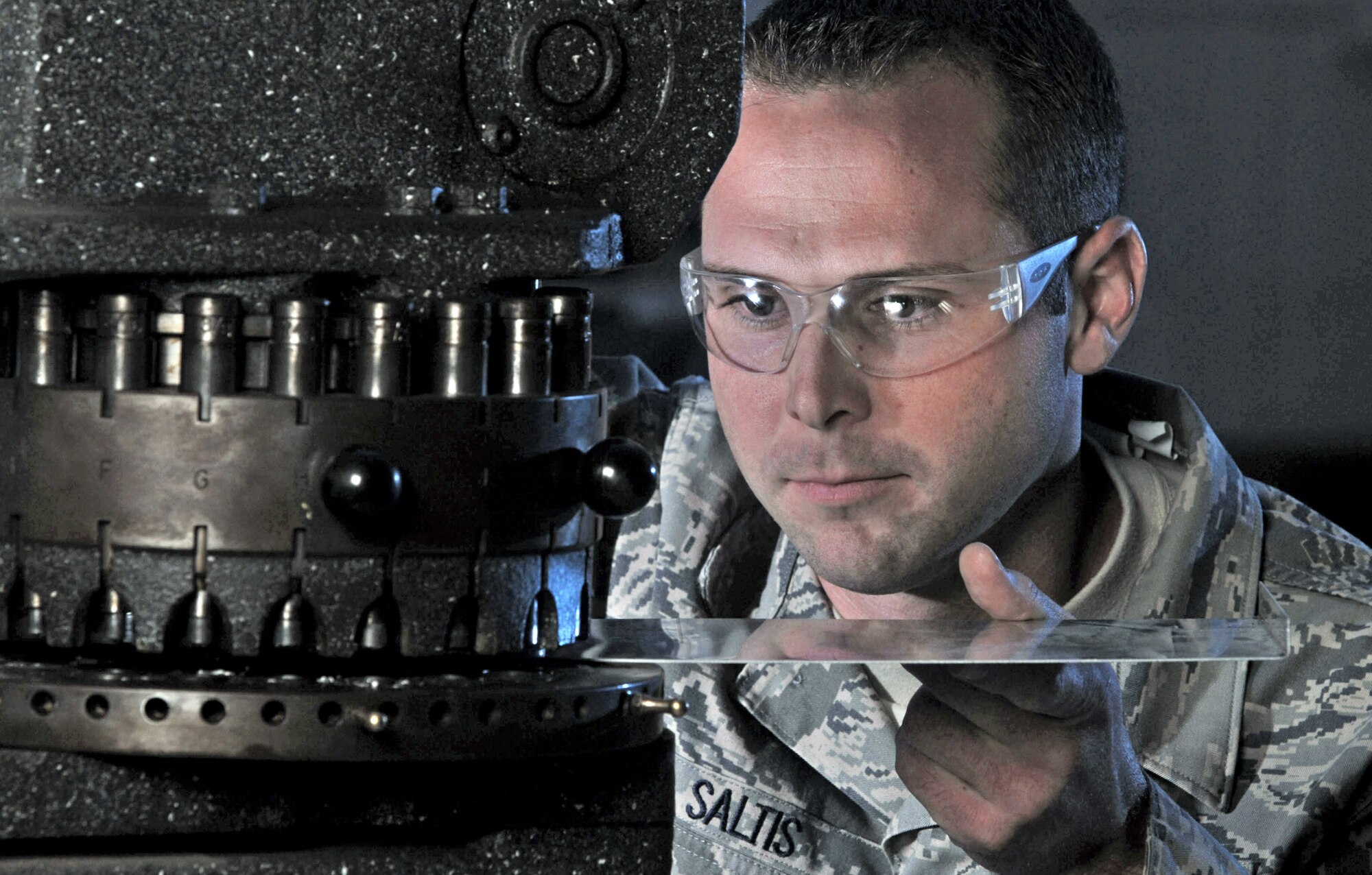 Senior Airman Jarrod Saltis aligns a rotex punch while fabricating a door panel for a C-17 Globemaster III cargo aircraft Nov. 28 at March Air Reserve Base, Calif. In addition to being the home of the Air Force Reserve Command's largest air mobility wing, the base hosts units from the Army, Navy and Marine Corps Reserve, and the Air National Guard. Airman Saltis is an aircraft structural maintenance technician from the 452nd Maintenance Squadron. (U.S. Air Force photo/Val Gempis)