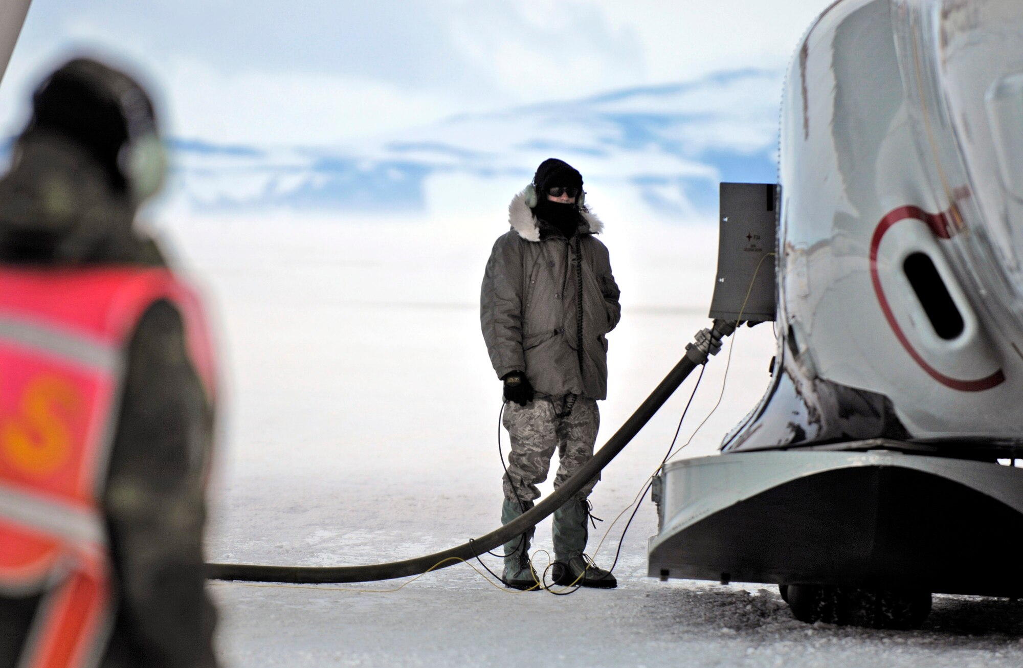 Staff Sgt. David Aymat and Tech. Sgt. Kevin Call refuel an LC-130 Hercules Nov. 26 on the annual sea ice runway near McMurdo Station, Antarctica, during Operation Deep Freeze. Ski-equipped LC-130s, crews and support personnel from the New York Air National Guard's 109th Airlift Wing are supporting the 13th Air Force-led Joint Task Force Support Forces Antarctica, Operation Deep Freeze. Operation Deep Freeze is a unique joint and total force mission that has supported the National Science Foundation and U.S. Antarctic Program that began in 1955. (U.S. Air Force photo/Tech. Sgt. Shane A. Cuomo) 
