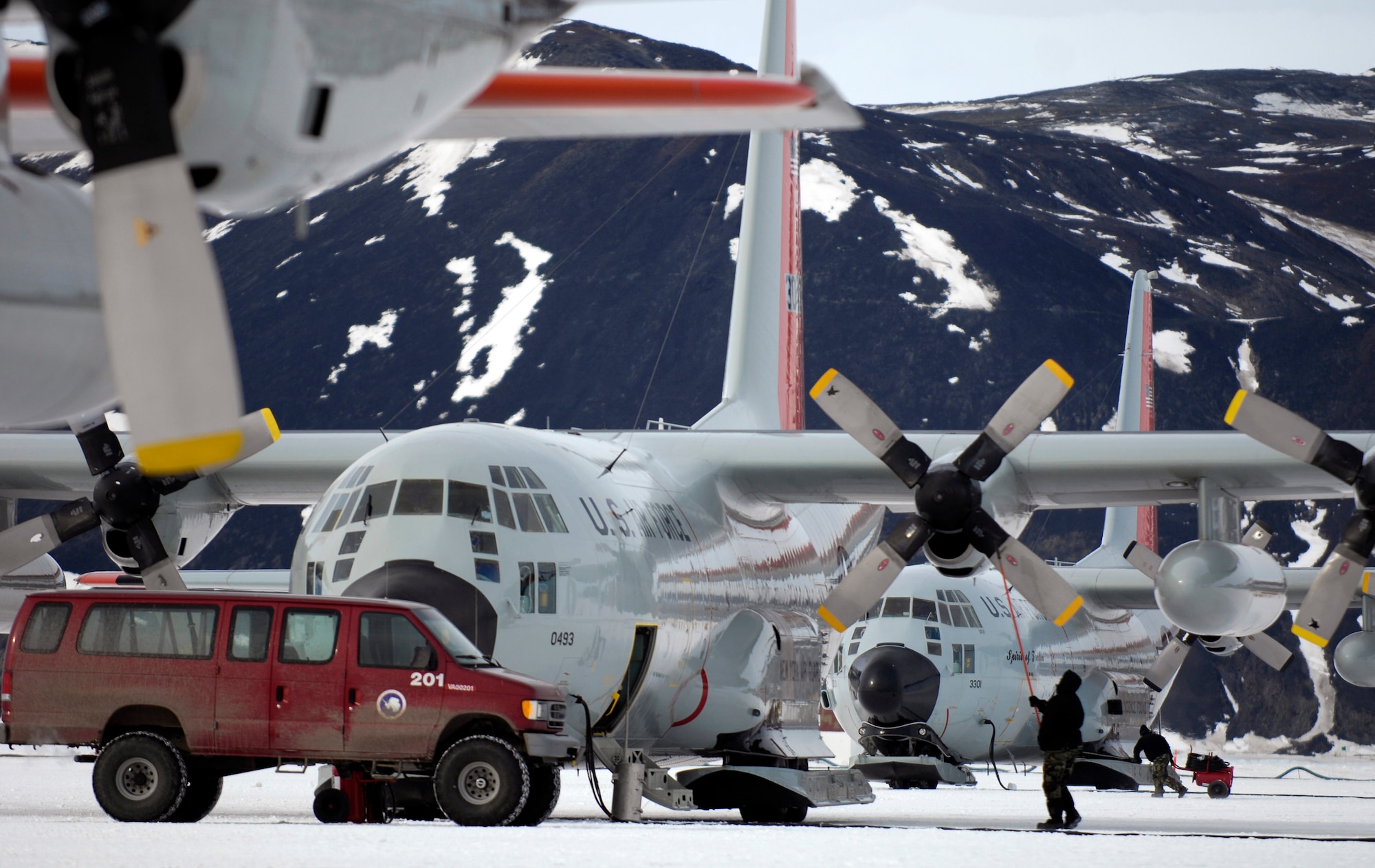 Maintenance crews work on LC-130 Hercules on the annual sea ice runway Nov. 26 near McMurdo Station, Antarctica, during Operation Deep Freeze. Ski-equipped LC-130s, crews and support personnel from the New York Air National Guard's 109th Airlift Wing are supporting the 13th Air Force-led Joint Task Force Support Forces Antarctica, Operation Deep Freeze. Operation Deep Freeze is a unique joint and total-force mission that has supported the National Science Foundation and U.S. Antarctic Program that began in 1955. (U.S. Air Force photo/Tech. Sgt. Shane A. Cuomo) 