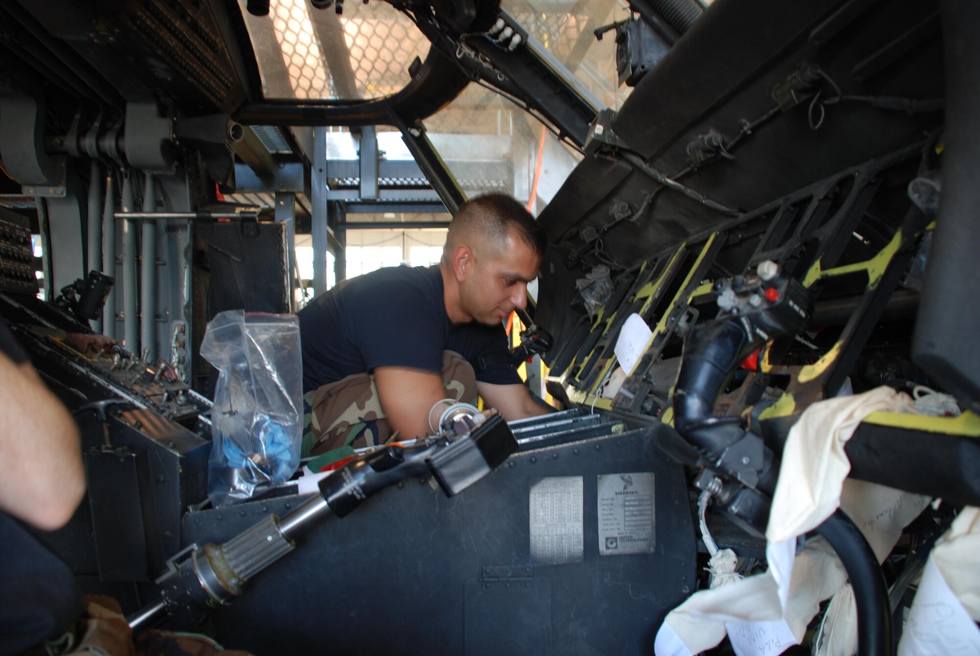 Air Force Reservist, TSgt. Christopher Ledesma, works on the HH-60 Pave Hawk helicopter during a phase inspection.  The phase inspection encompasses an inspection and cleaning of the entire Pave Hawk.  The Pave Hawk is a highly modified version of the Army Black Hawk helicopter which features an upgraded communications and navigation suite that includes integrated inertial navigation/global positioning/Doppler navigation systems, satellite communications, secure voice, and Have Quick communications. (U.S. Air Force Photo/2nd Lt. Jaime Pinto)
