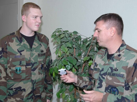 Airman 1st Class Ross Brow, 72nd Mission Support Squadron customer service, discusses the Tinker 500 goals with Lt. Col. Dave Parr, 72nd Operations Support Squadron commander.  Airman Brow was able to explain the meaning of the Tinker 500 goals and earned his Tinker 500 race car.  (Air Force Photo by Kathy Paine)