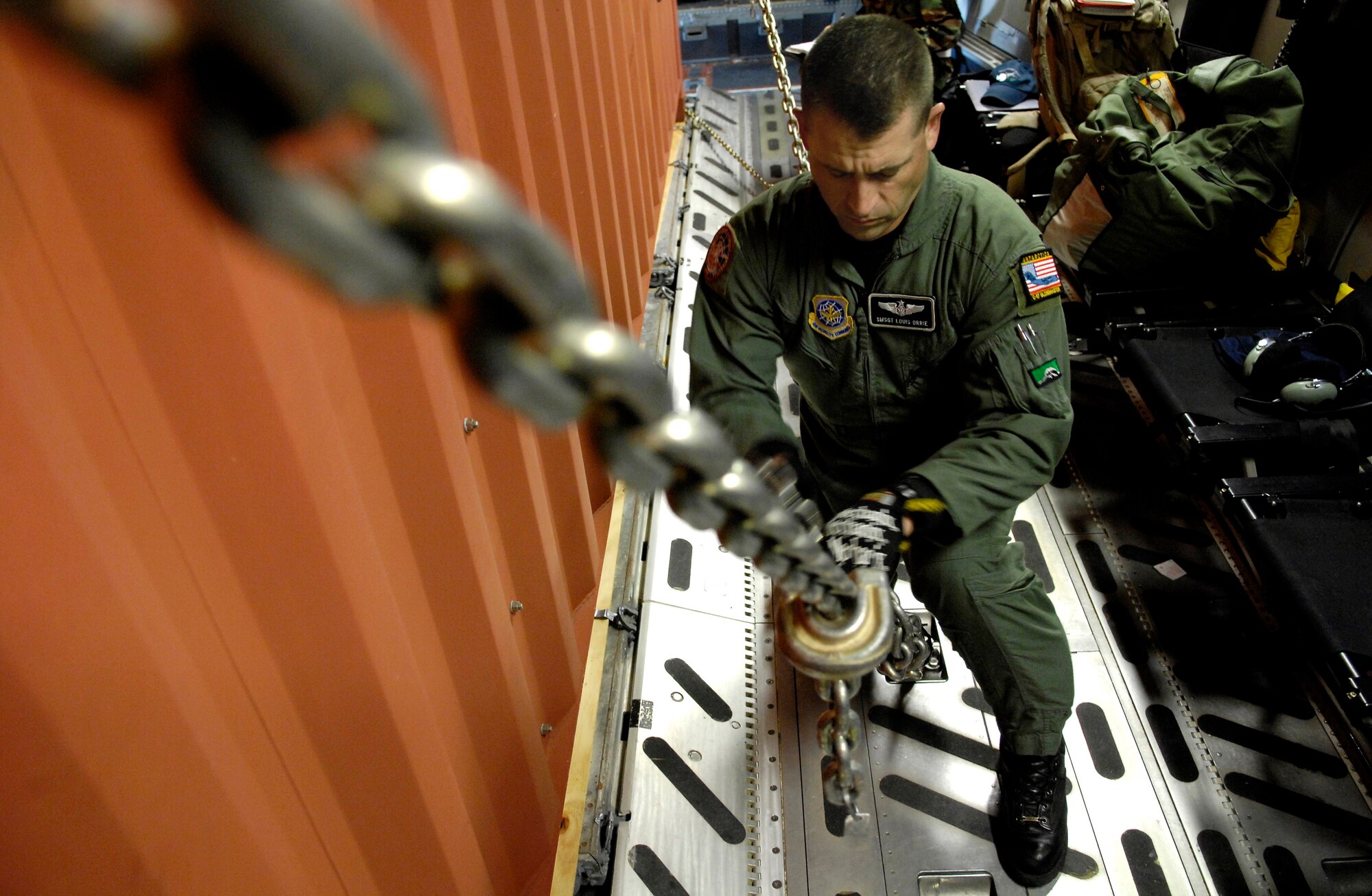 Senior Master Sgt. Louis Orrie tightens a cargo chain on a C-17 Globemaster III prior to taking off Nov. 26 from Christchurch, New Zealand, during Operation Deep Freeze. Sgt. Orrie, a loadmaster, along with other Reserve and active duty Airmen from McChord Air Force Base, Wash. are at Christchurch supporting the 13th Air Force-led Joint Task Force Support Forces Antarctica, Operation Deep Freeze. Operation Deep Freeze is a unique joint- and total-force mission that has supported the National Science Foundation and U.S. Antarctic Program that began in 1955. (U.S. Air Force photo/Tech. Sgt. Shane A. Cuomo) 