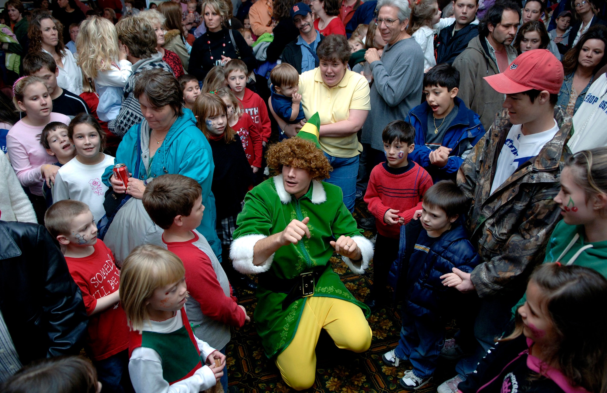 "Buddy the Elf," portrayed by Capt. Clay Couitt, passes out presents to each one of the children attending the Arnold Air Force Base, Tenn., Christmas party Dec. 2. (U.S. Air Force photo/Staff Sgt. Bennie J. Davis III)